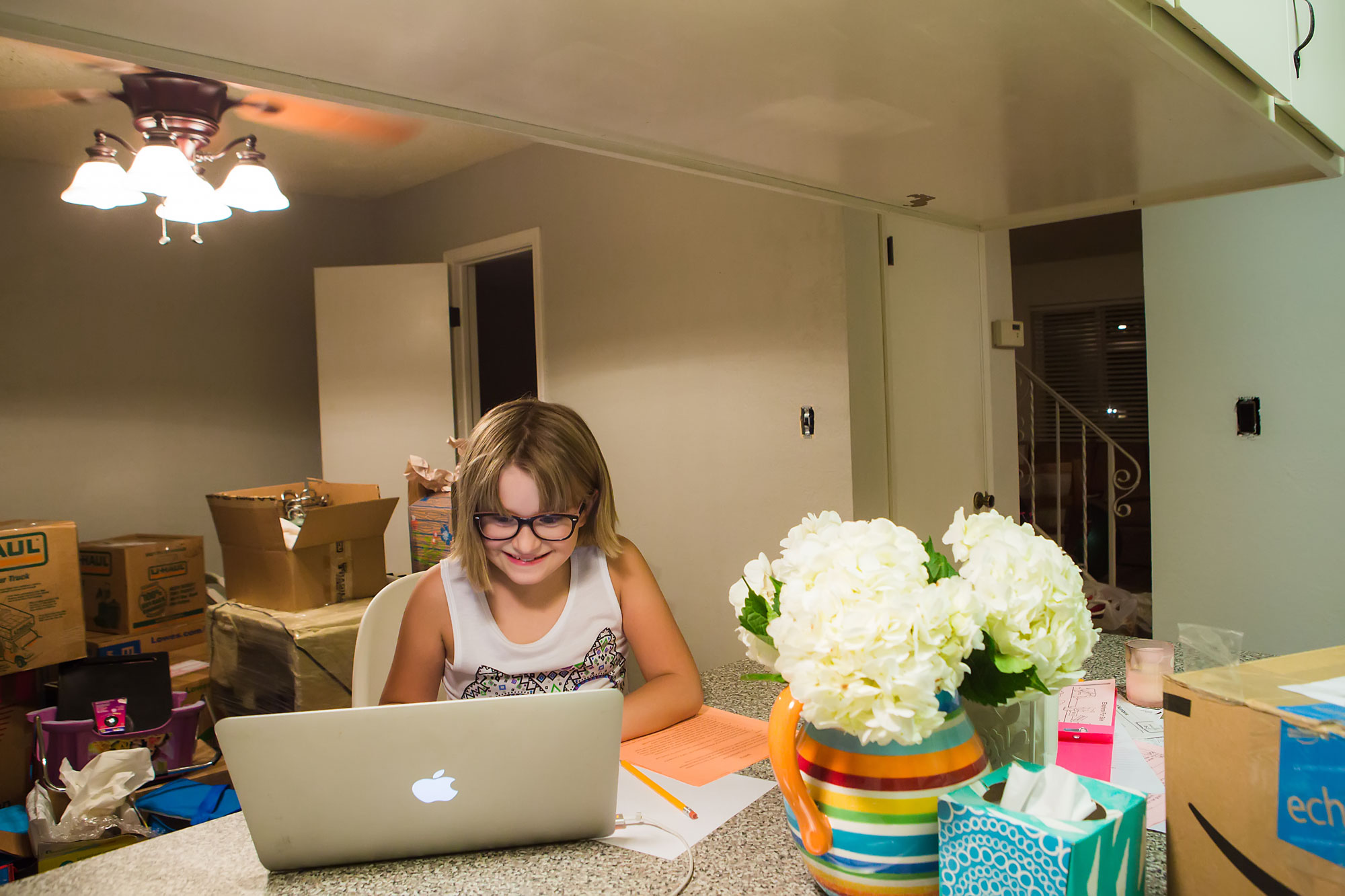 girl at laptop in kitchen - documentary family photography