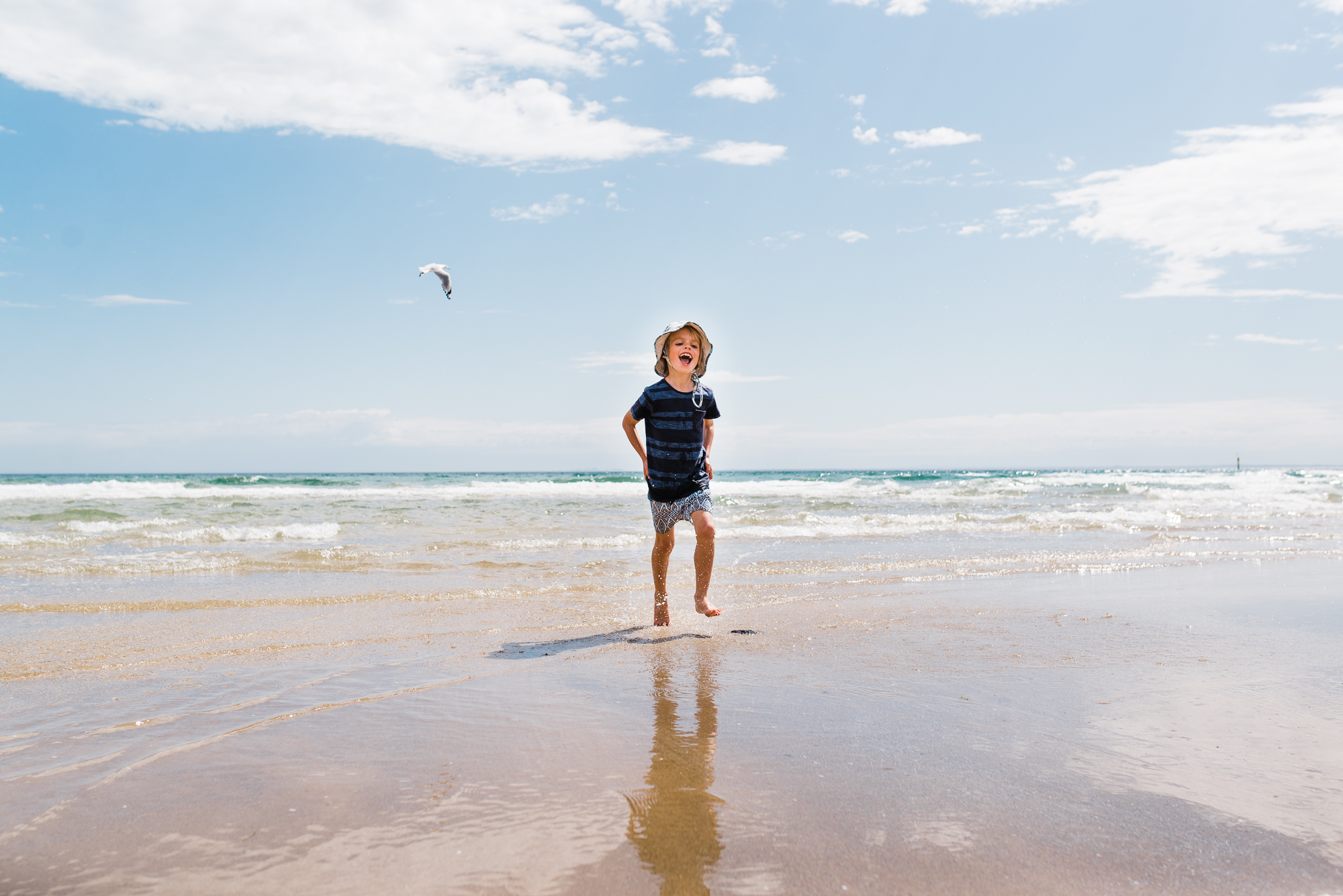 boy alone on beach - documentary family photography