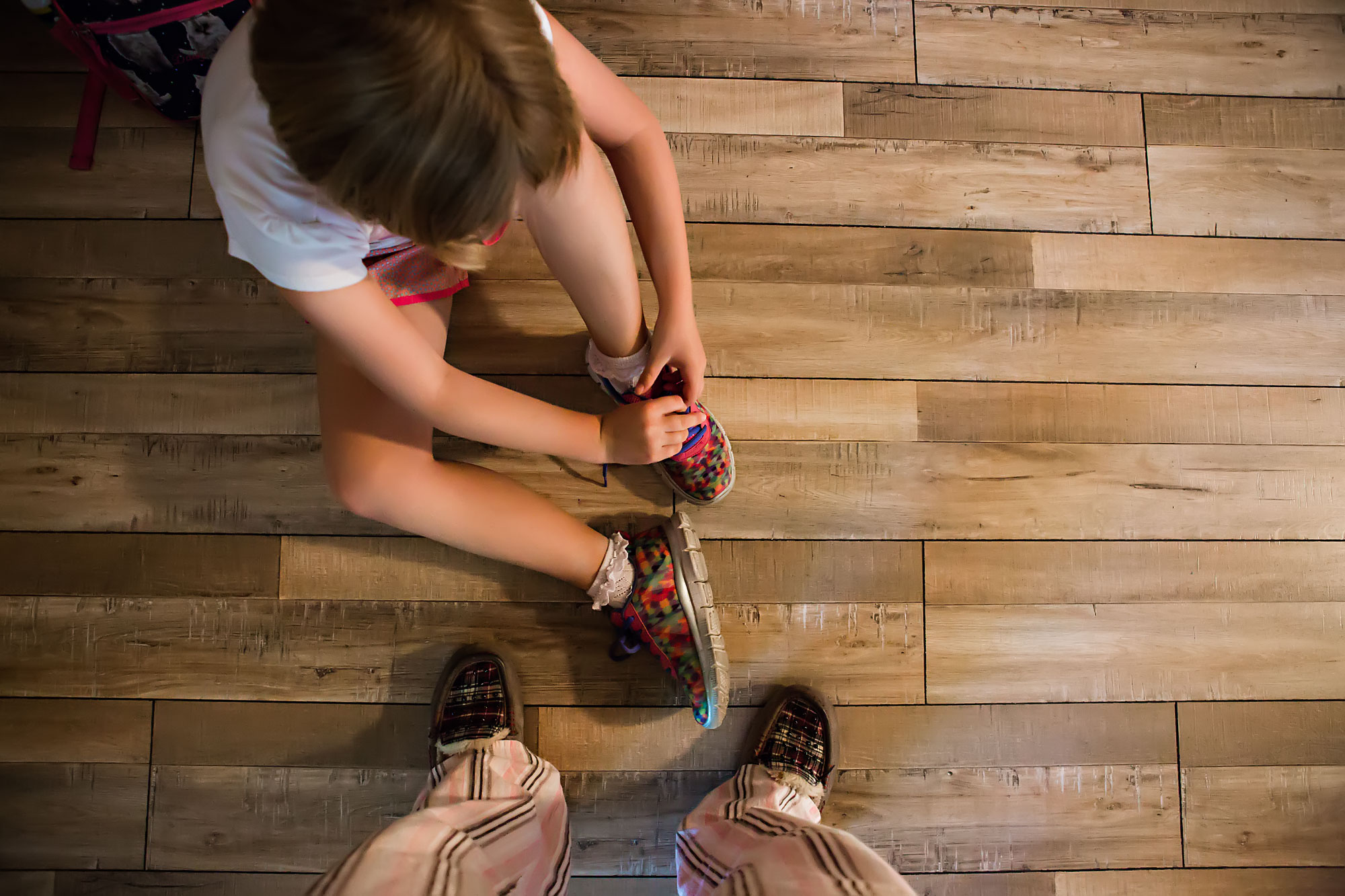 child puts on shoes - Documentary Family Photography