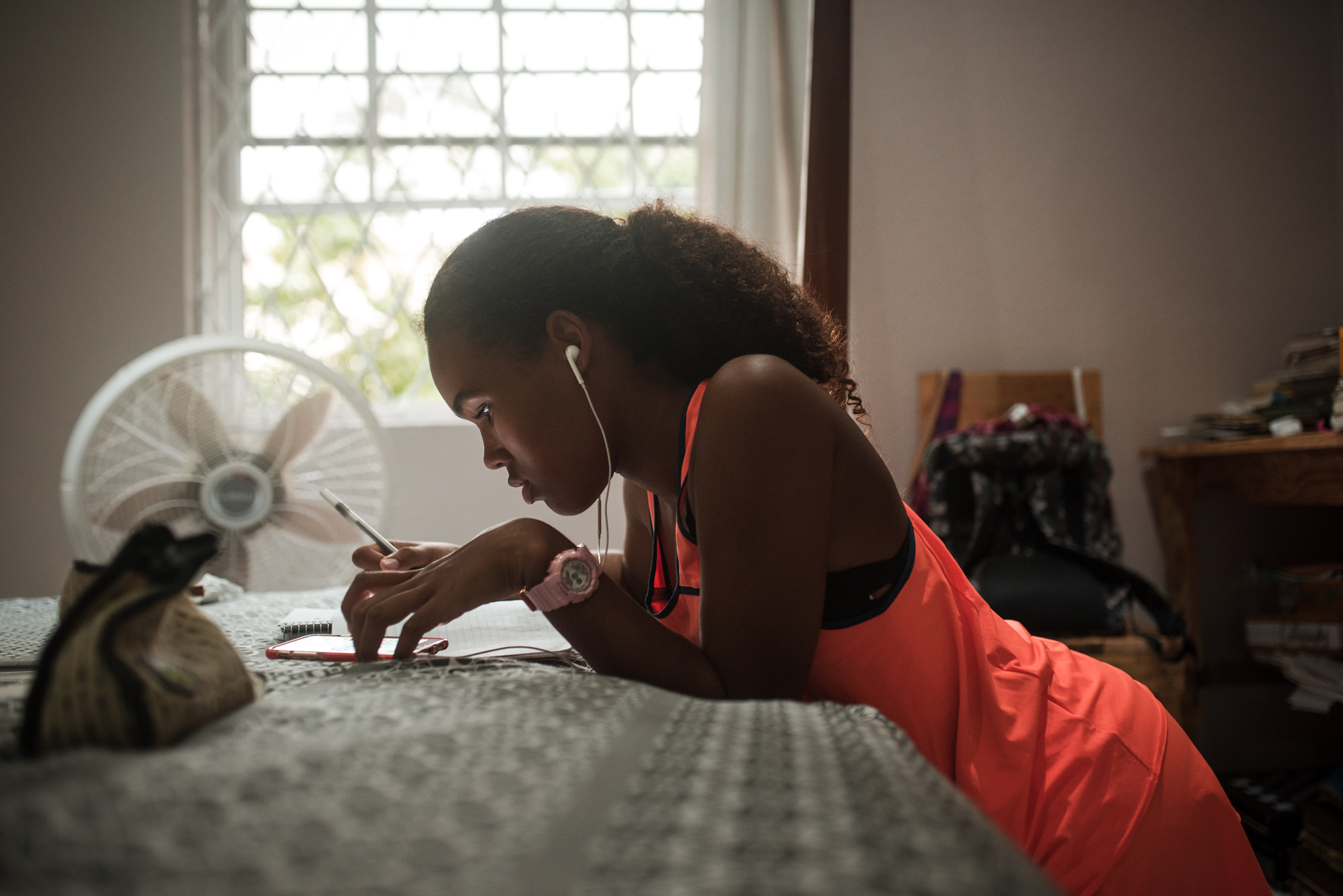 girl doing homework near window - Documentary Family Photography