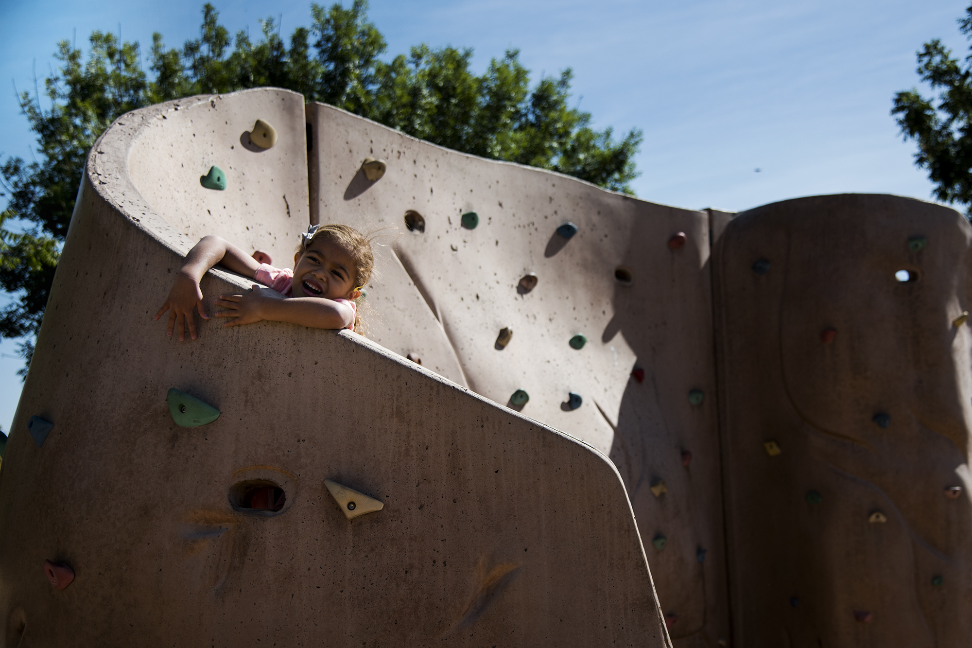 kid on climbing wall - documentary family photography