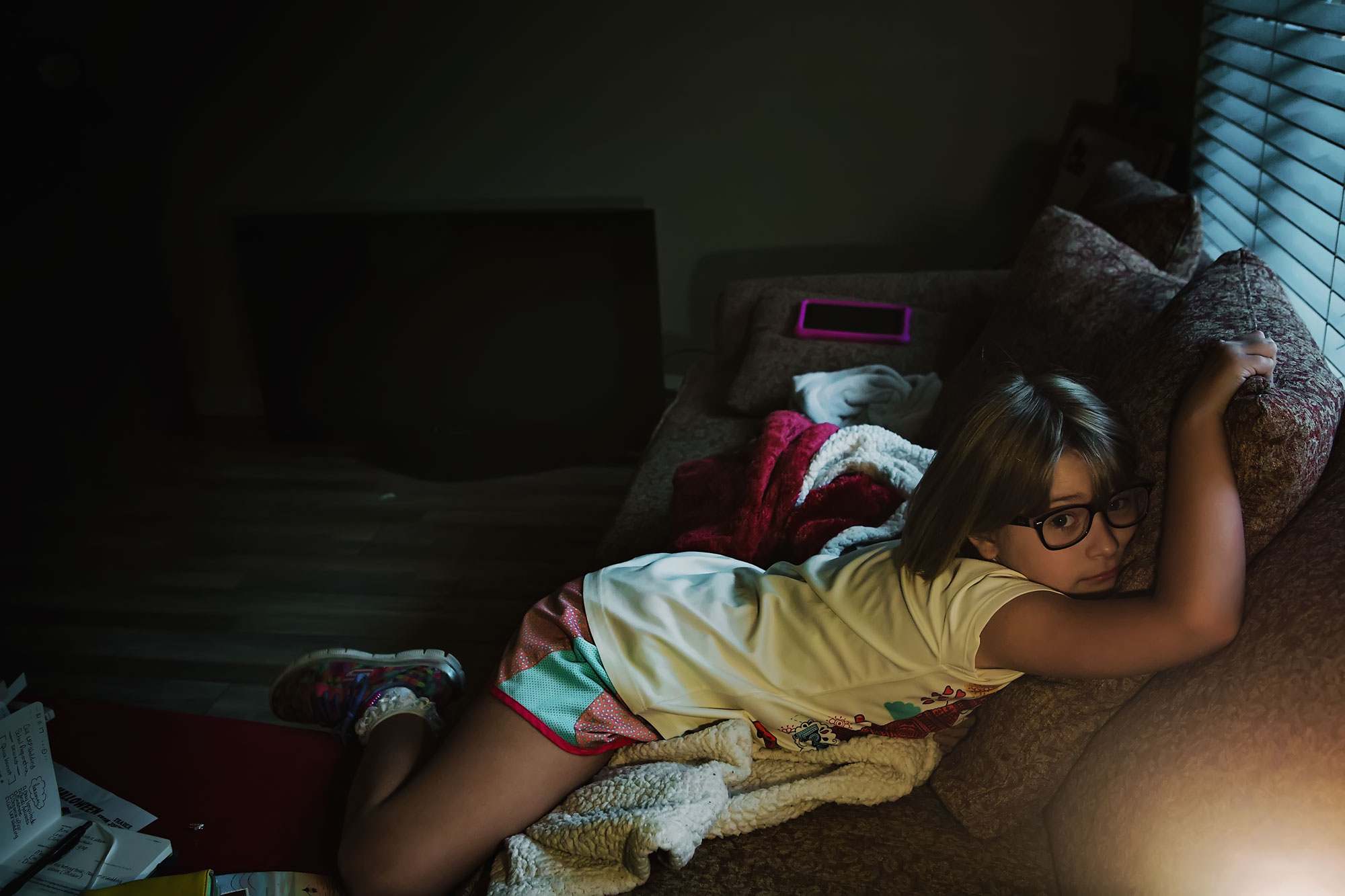 girl sprawled on couch - documentary family photography