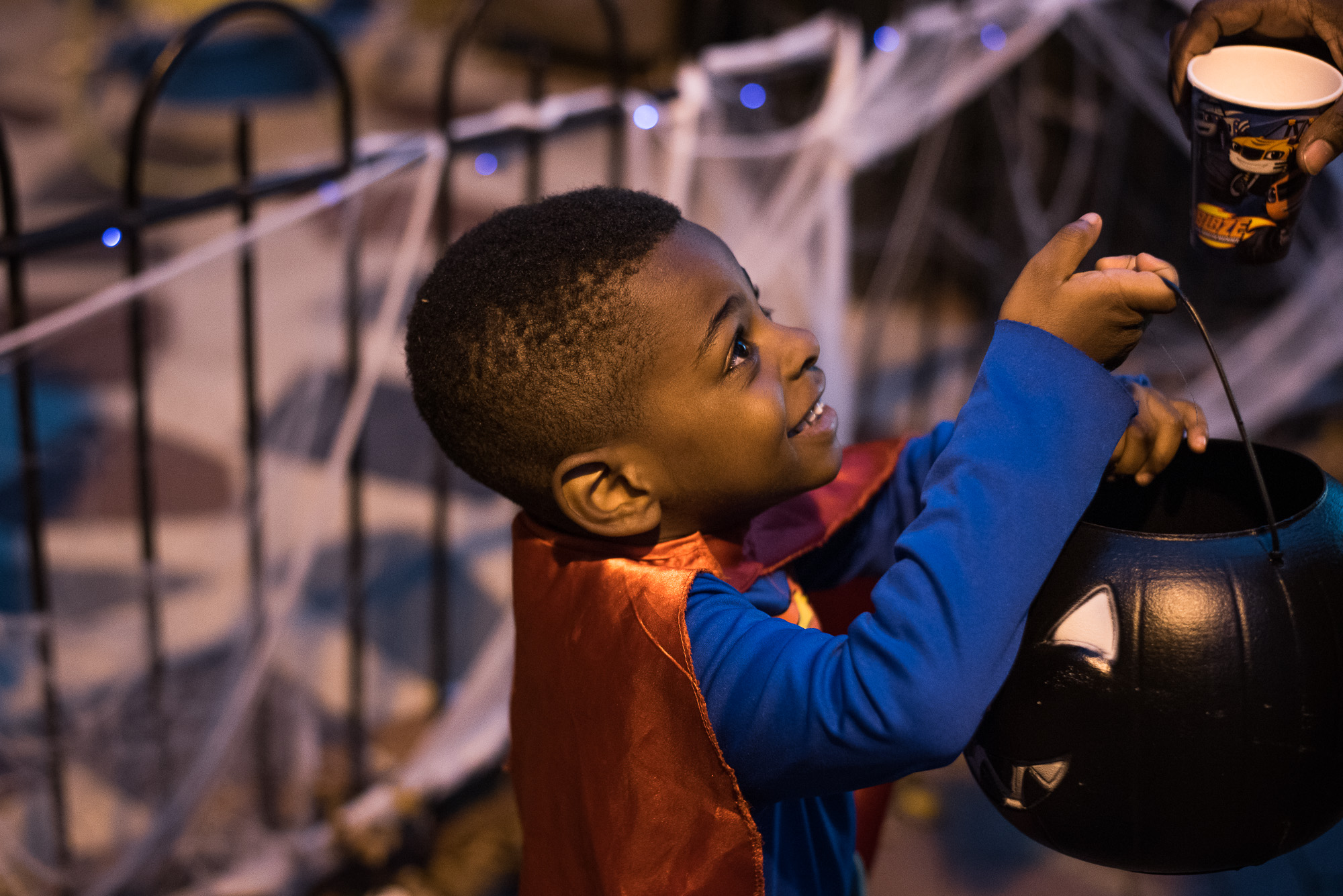 little boy with trick or treat bucket - documentary family photography