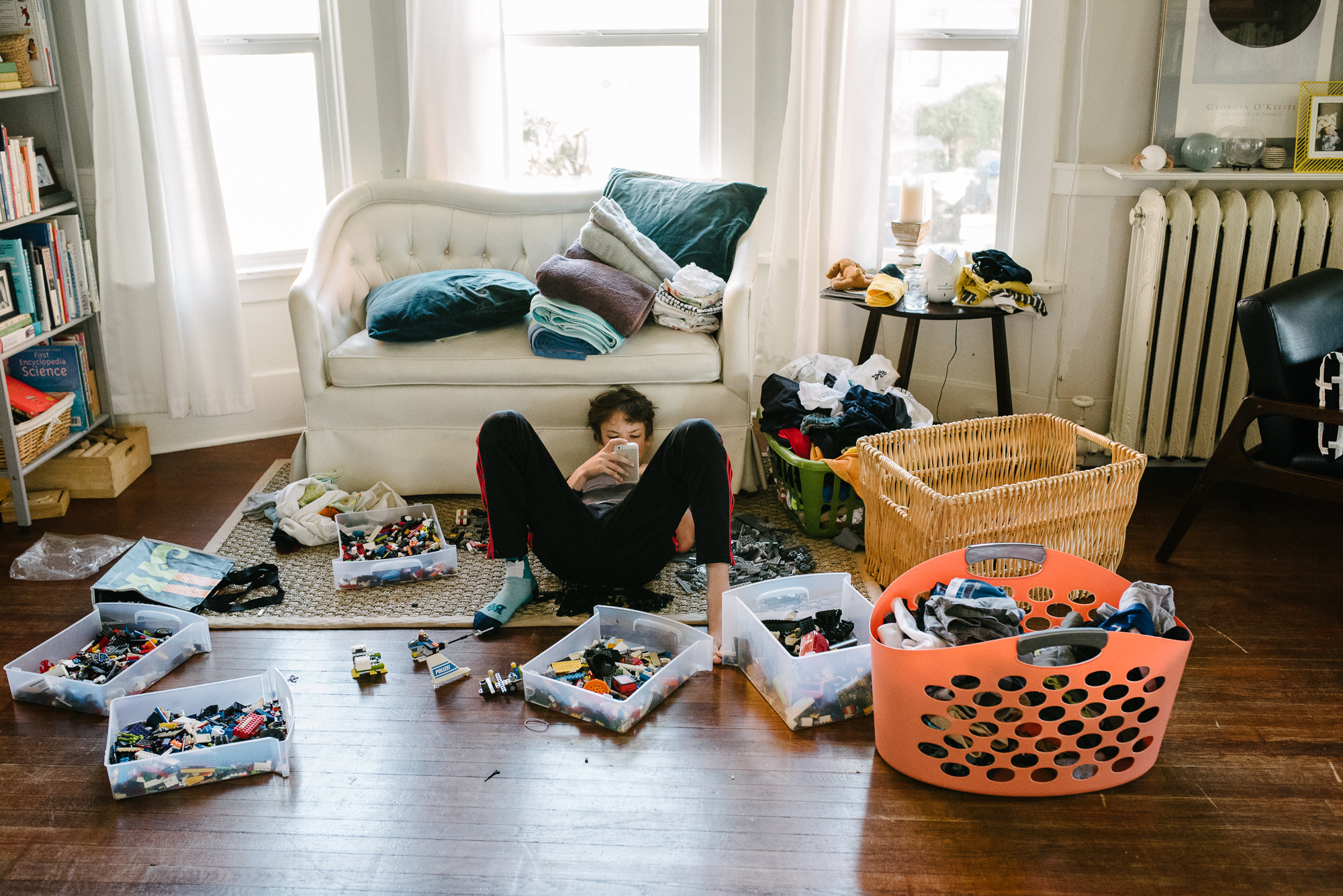 boy on floor amidst legos - documentary family photography
