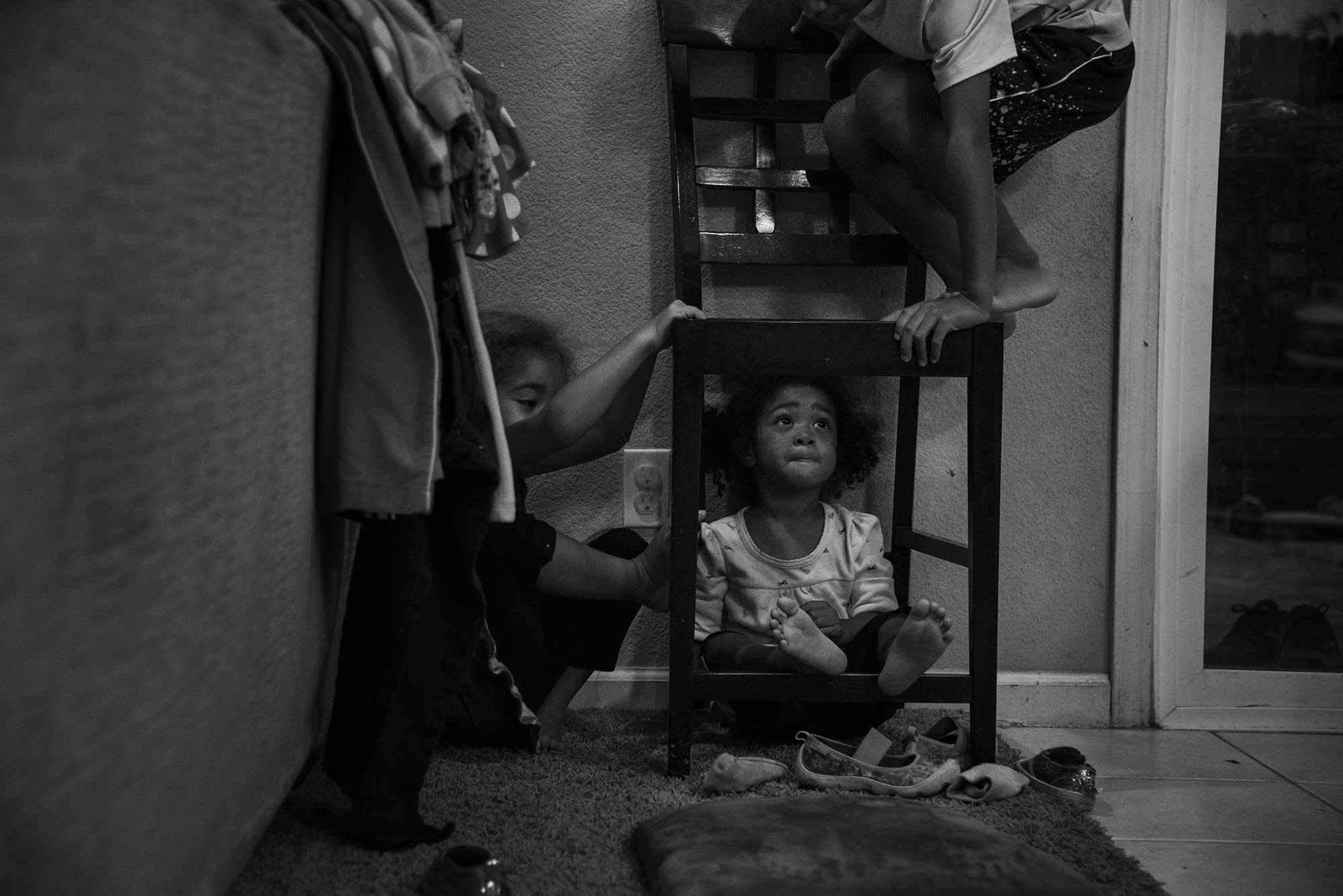 kids climbing on chair in kitchen - documentary family photography