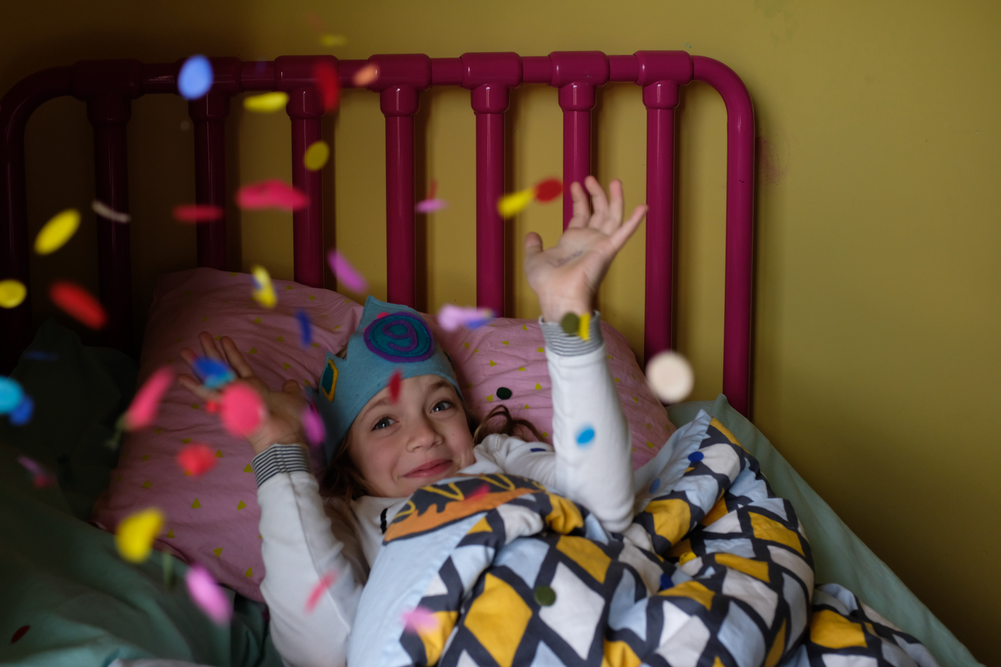 girl with birthday crown and confetti - documentary family photography