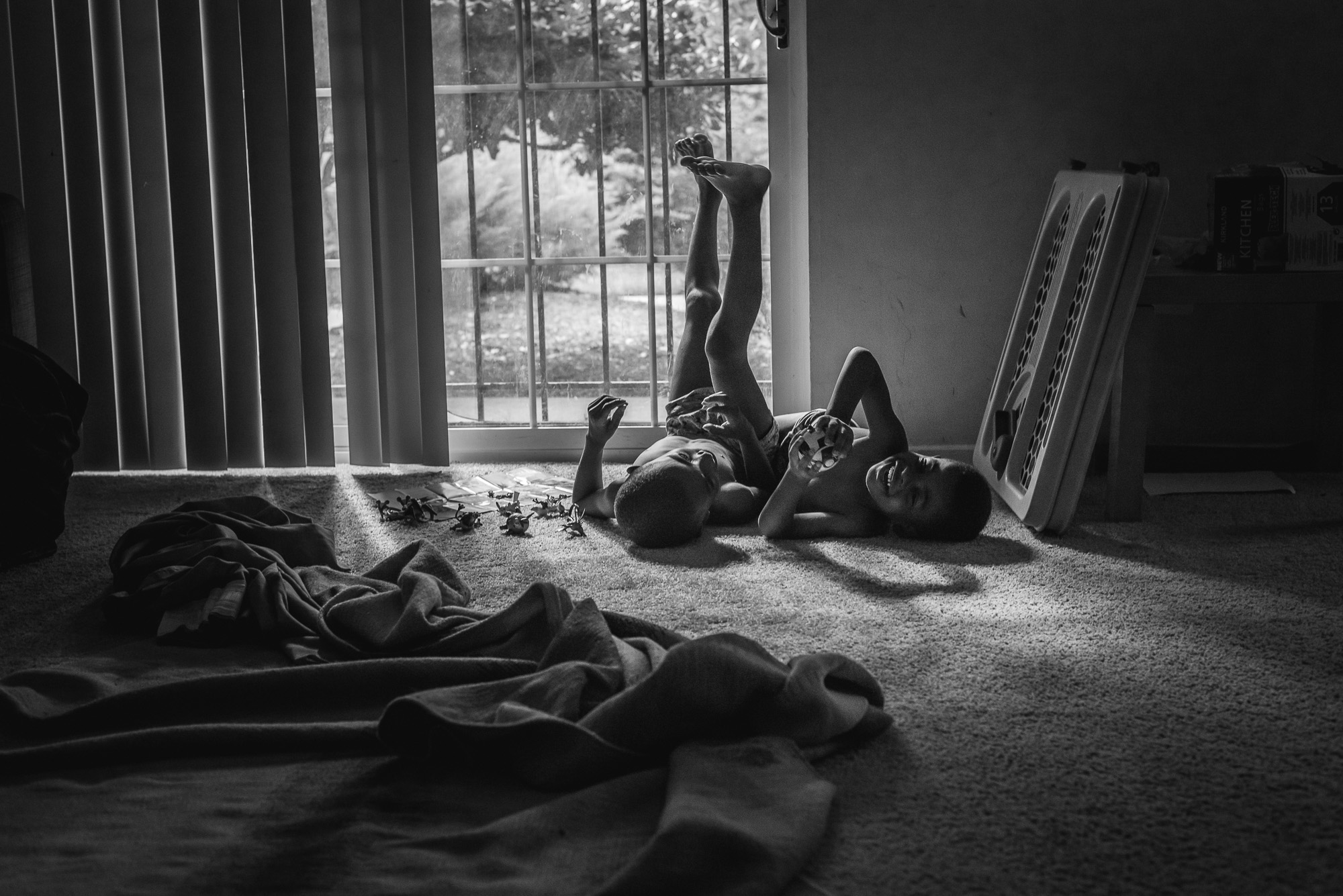 kids on floor near window - documentary family photography