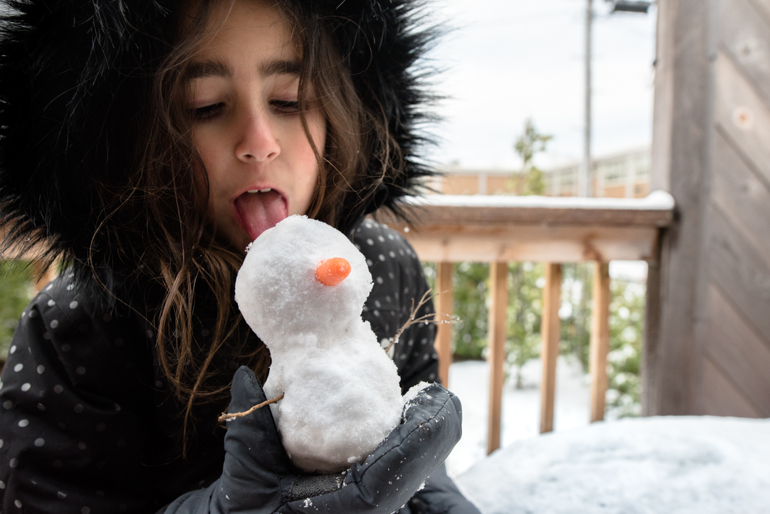 girl with mini snowman - documentary family photography