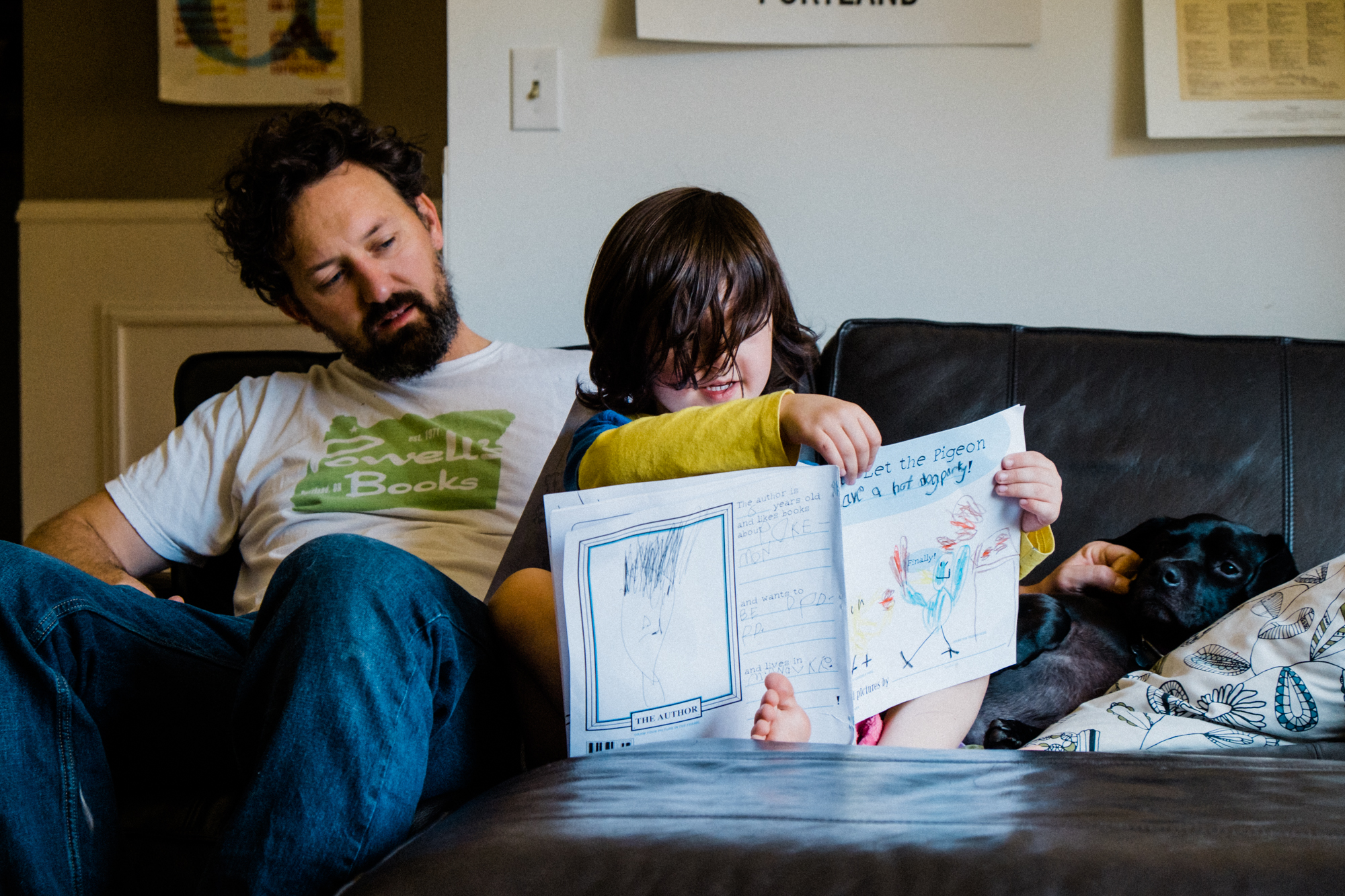 boy with father and workbook - documentary family photography