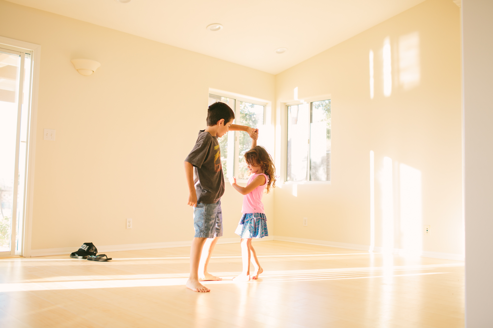 kids dancing in empty room - documentary family photography