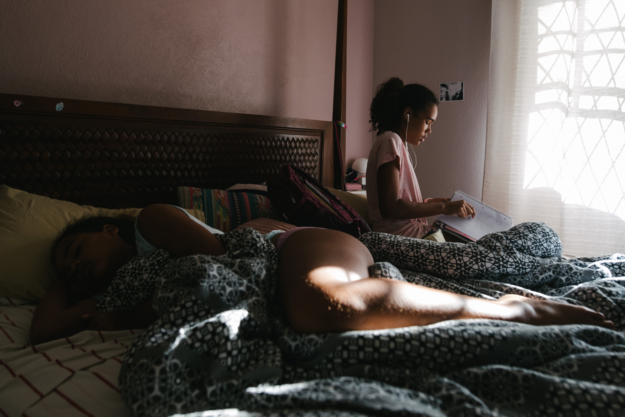 girls on bed in sunlight - documentary family photography