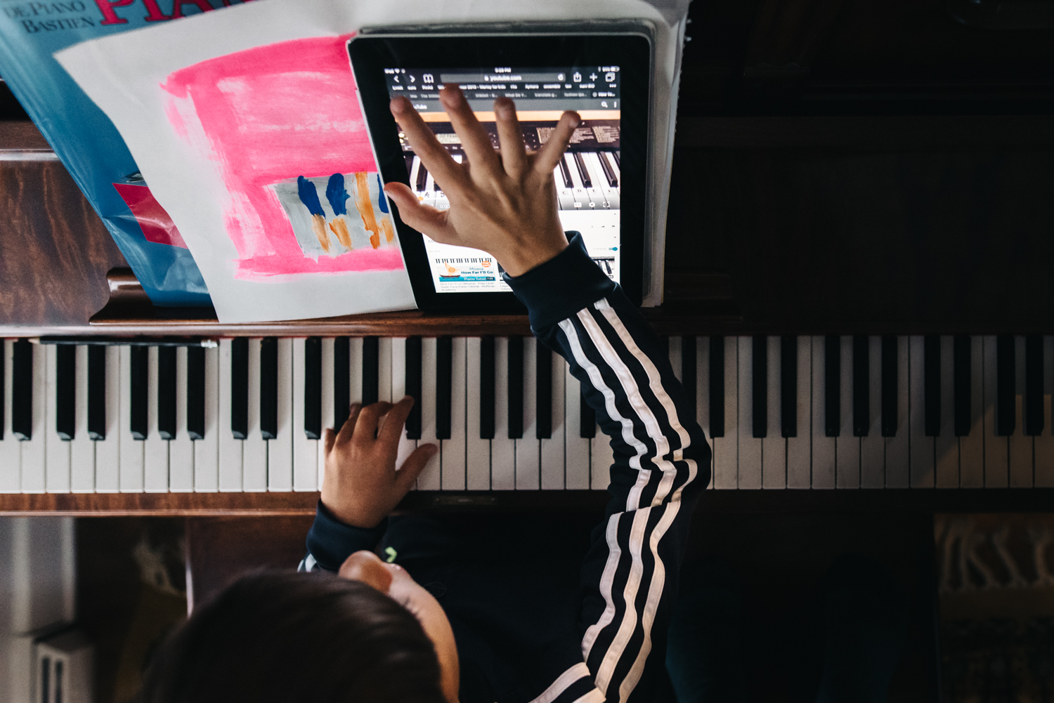 boy playing piano - documentary family photography