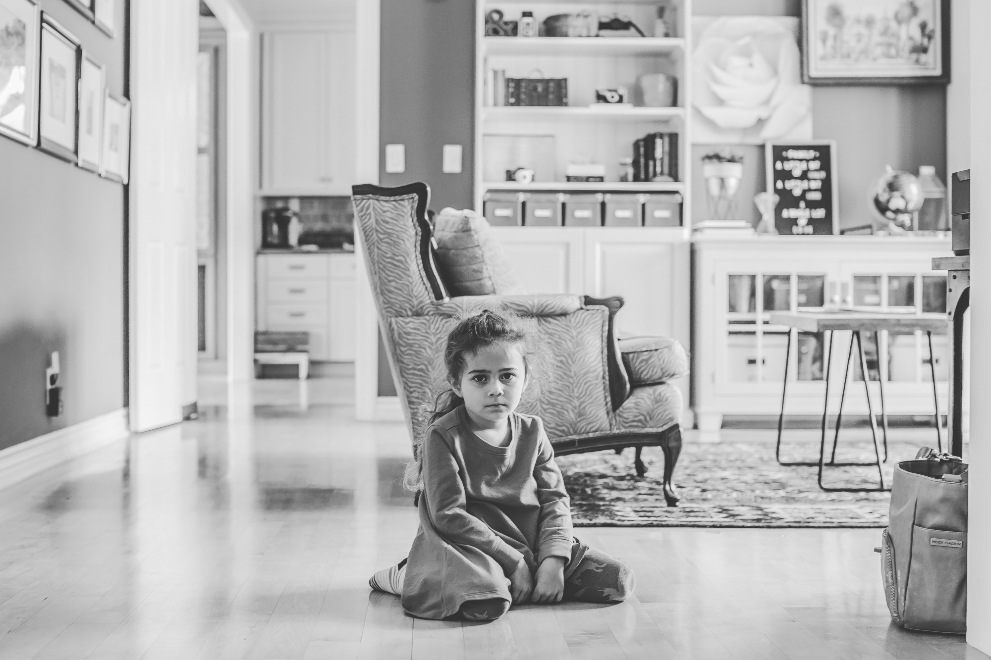girl pouts on floor -documentary family photography