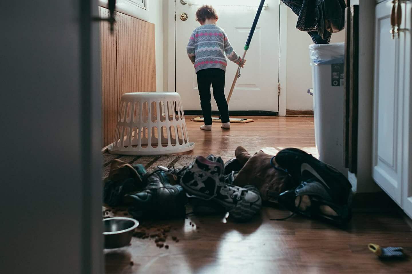 girl with upturned laundry basket - Documentary Family Photography