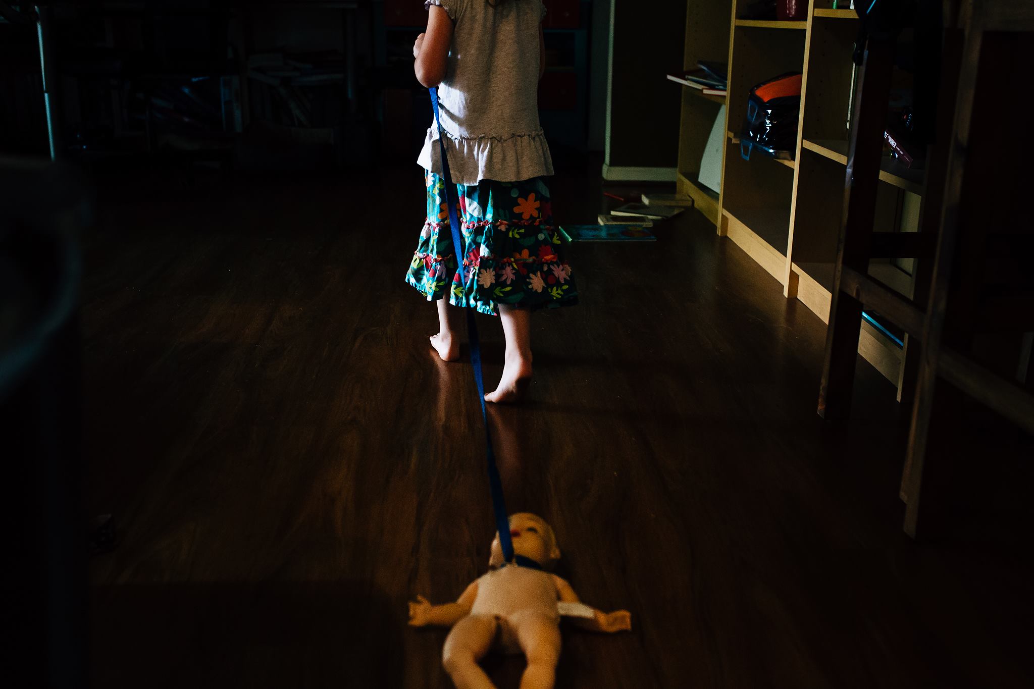 girl pulling doll by leash - Documentary Family Photography