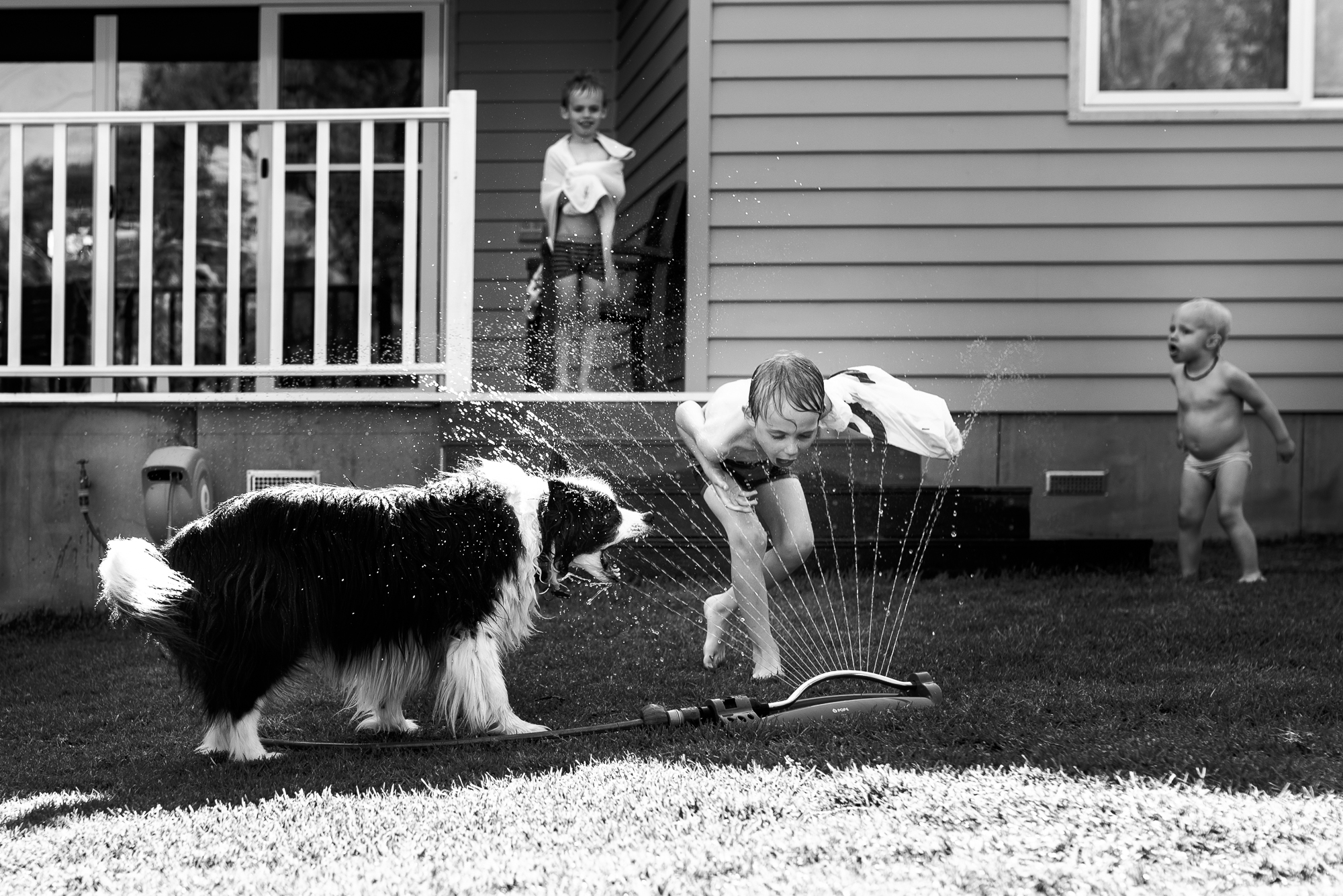 kids play in sprinklers - Documentary Family Photography
