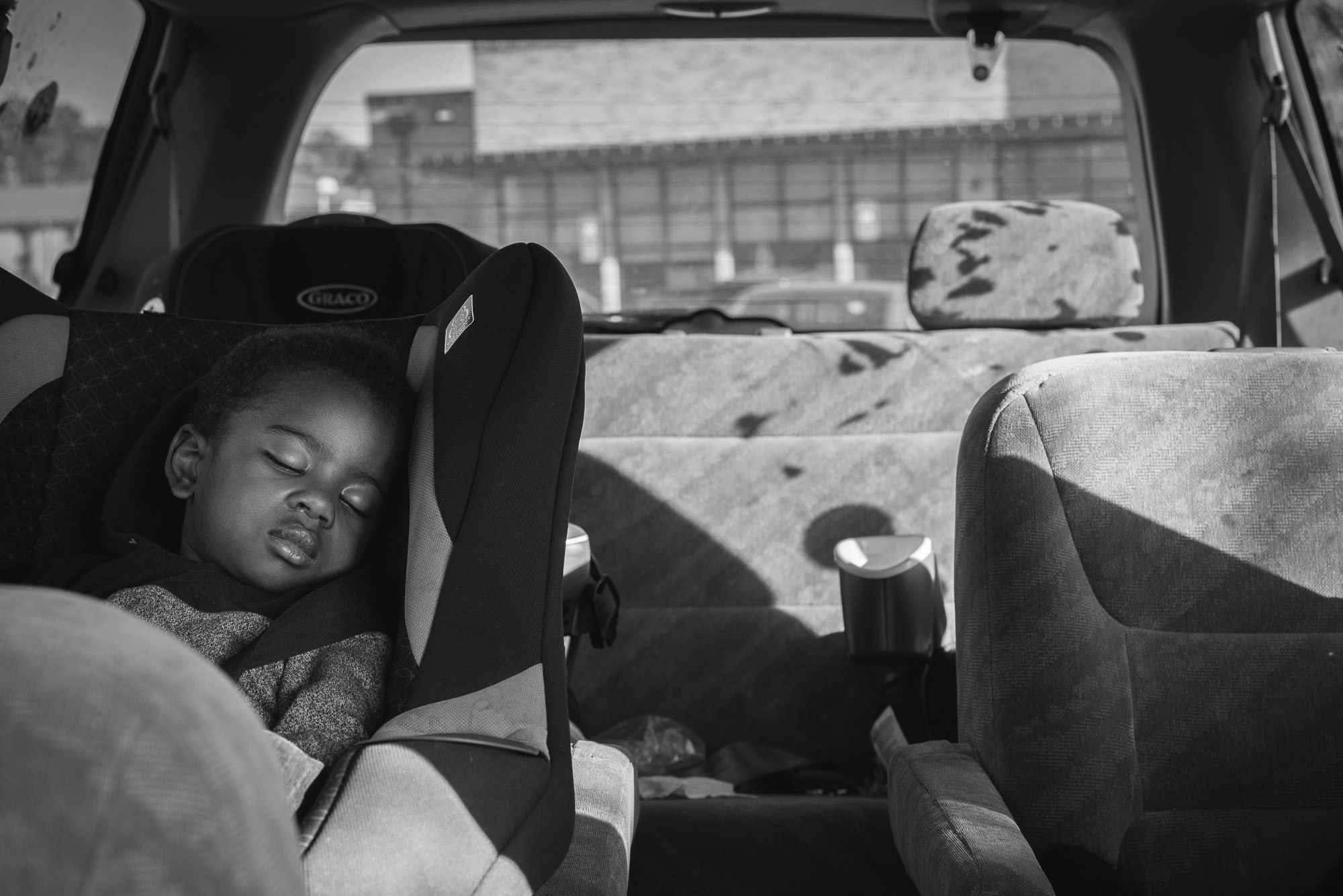 boy asleep in car seat - Documentary Family Photography