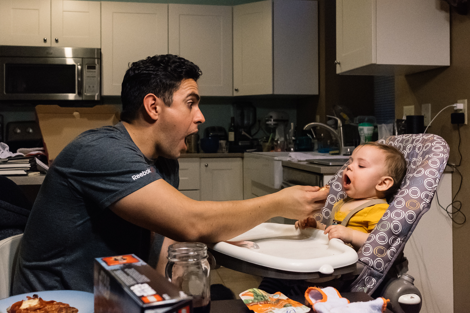 Father feeds baby - Documentary Family Photography