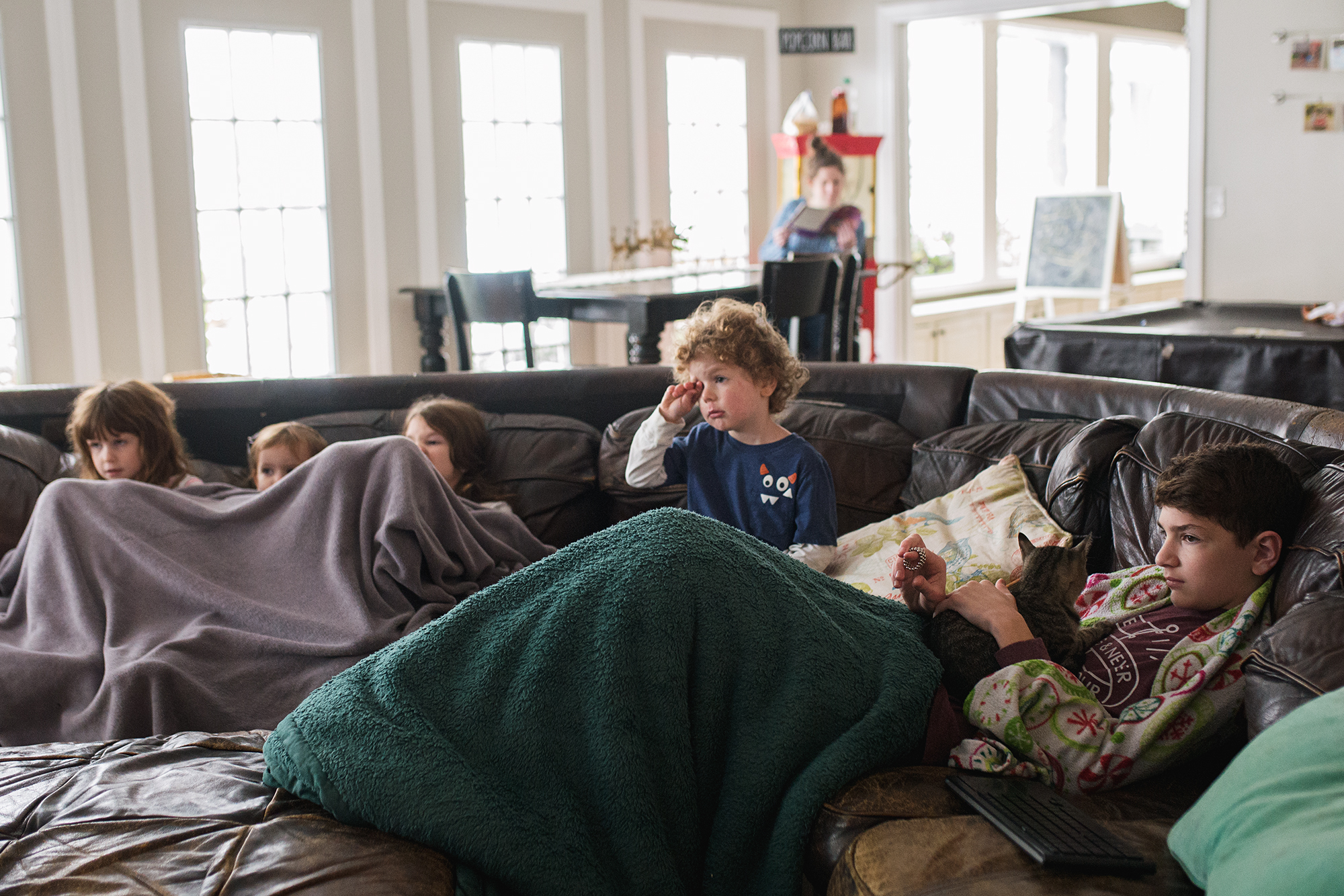 kids cuddled on couch - documentary family photography