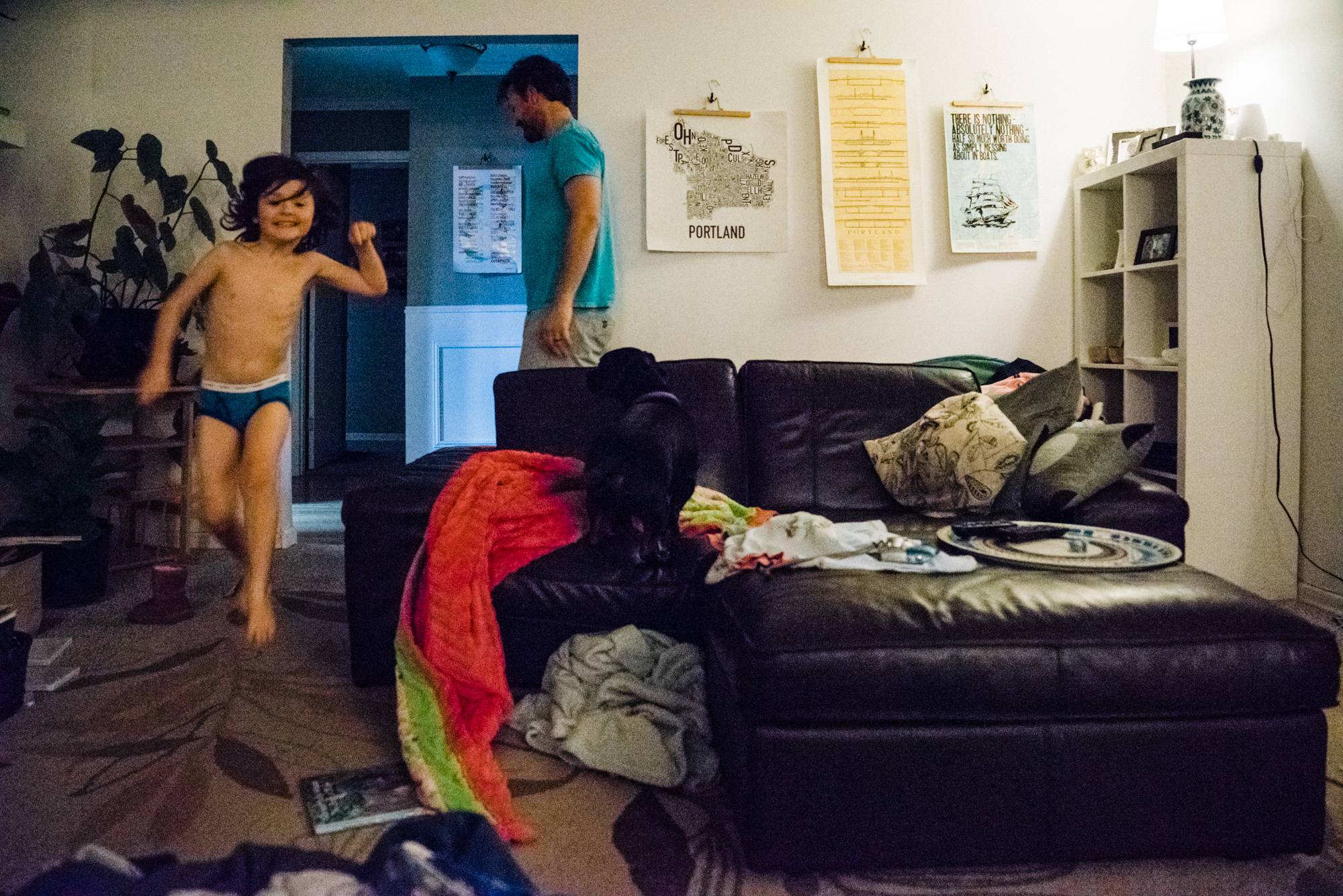 kid jumping off couch - documentary family photography
