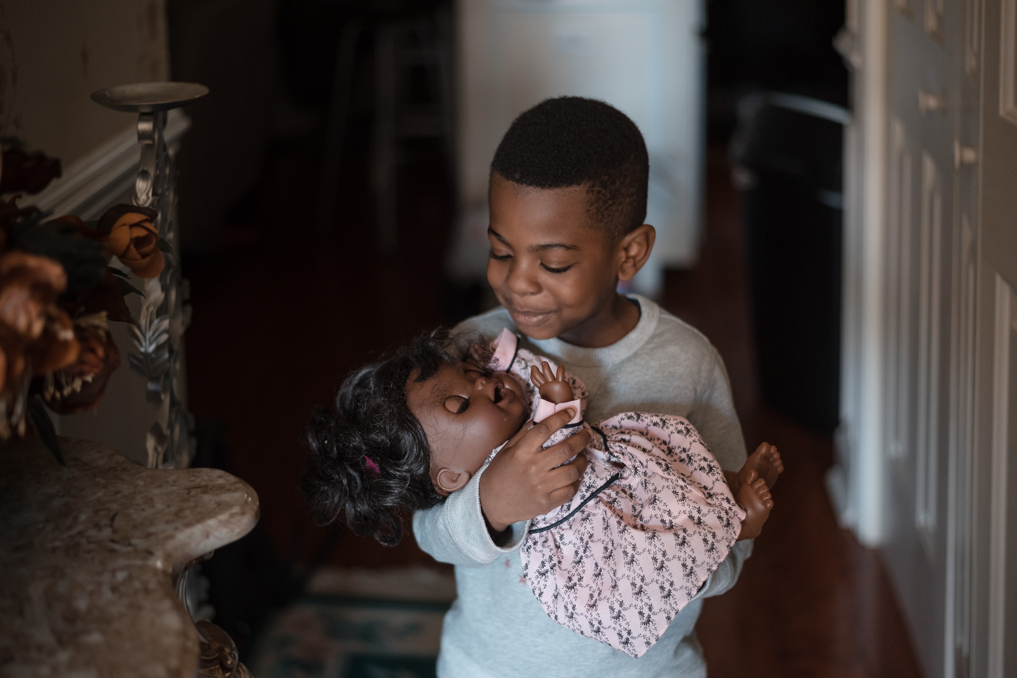 boy with baby doll - Documentary family photography