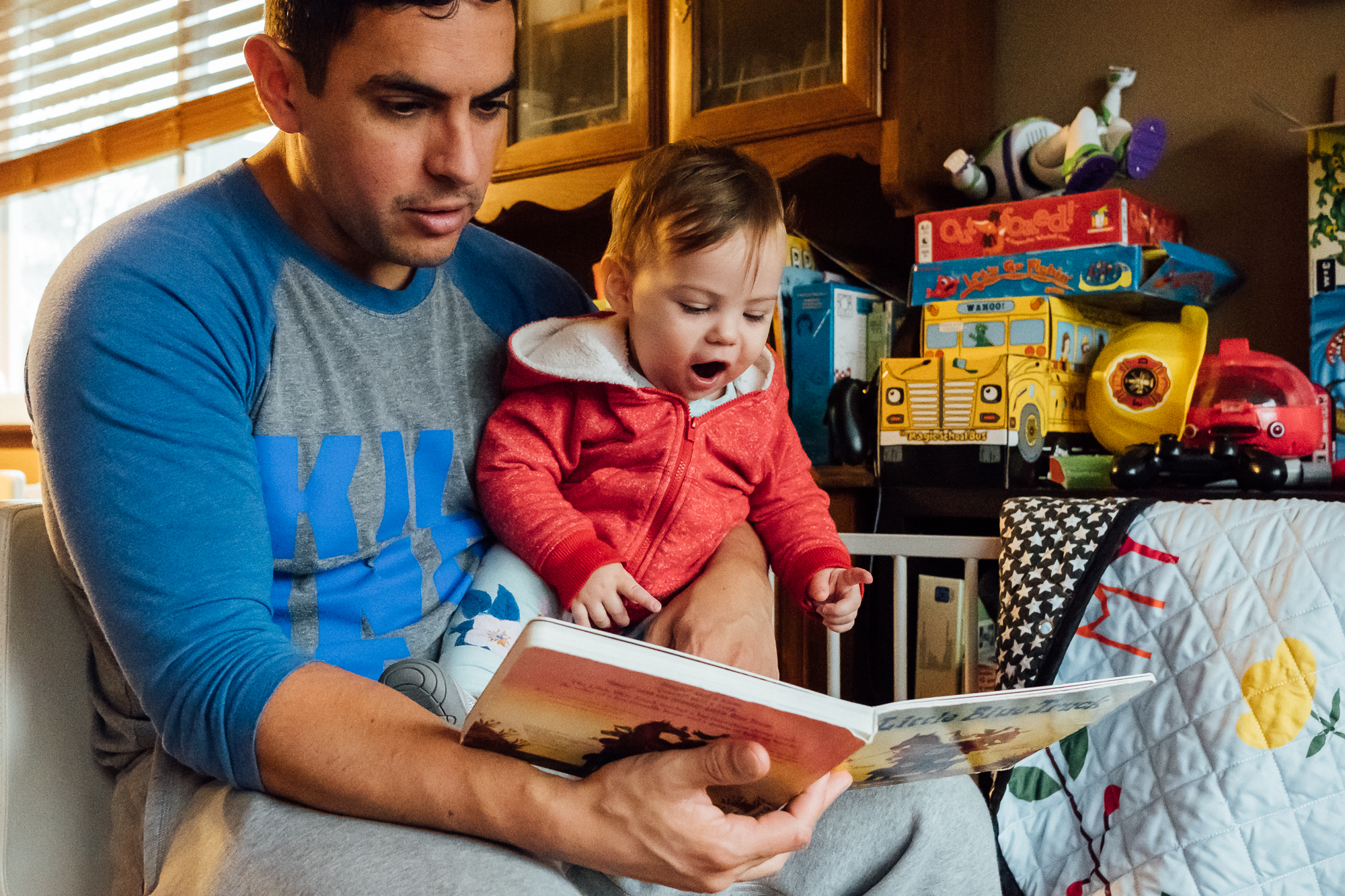 father reads to baby - Documentary family photography