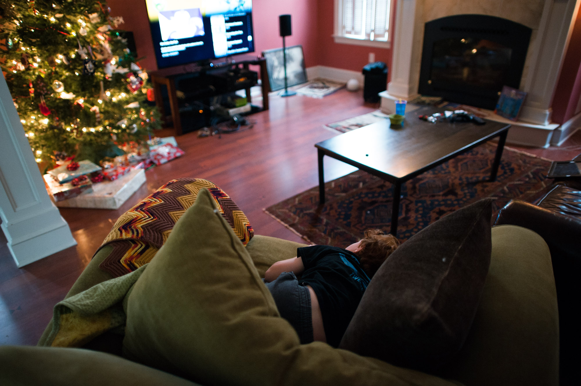 boy on couch in front of Christmas tree - Documentary family photography