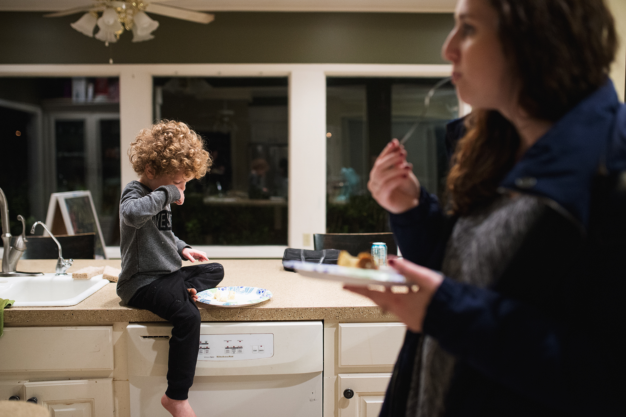 child eating on counter top - Documentary Family Photography