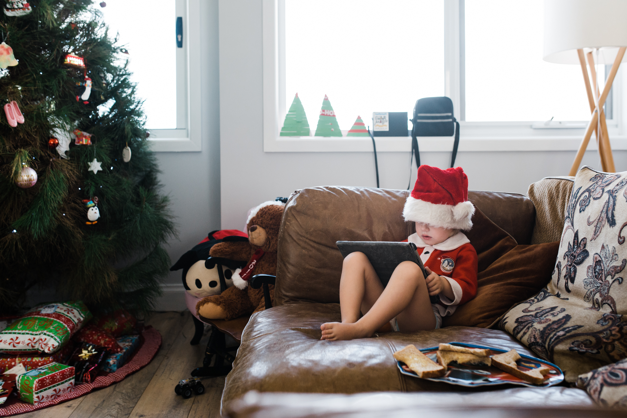 kid in Santa jammies - Documentary Family Photography
