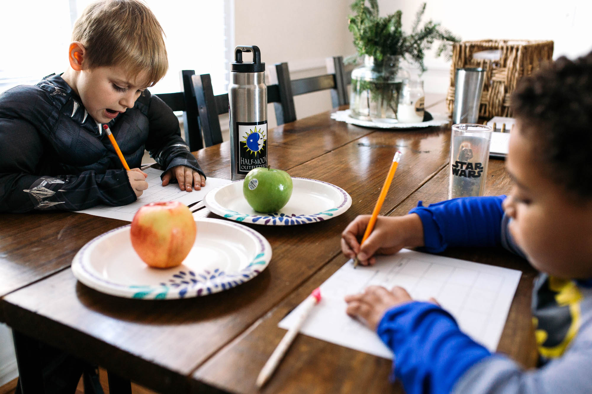kids doing homework with apple snacks - Documentary Family Photography