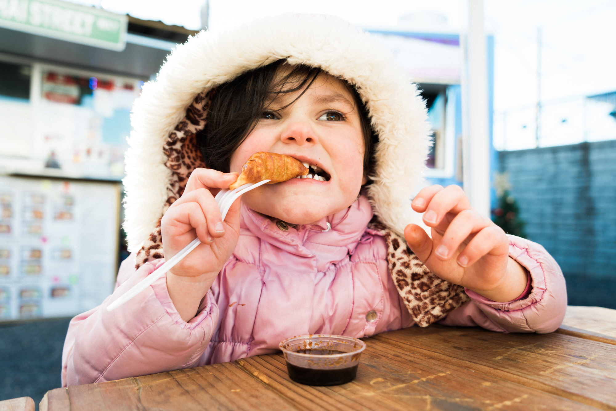 girl in coat eating - Documentary Family Photography