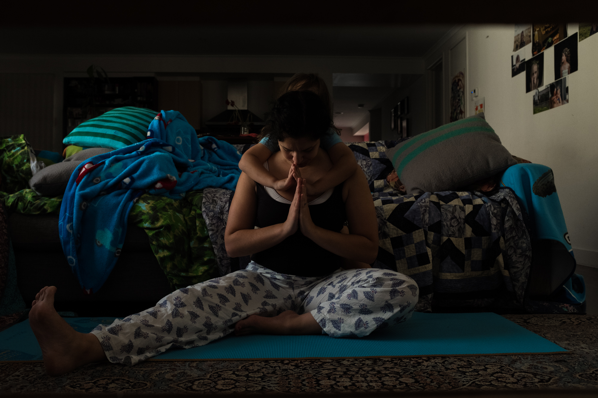 woman does yoga with kid hanging around - Documentary Family Photography