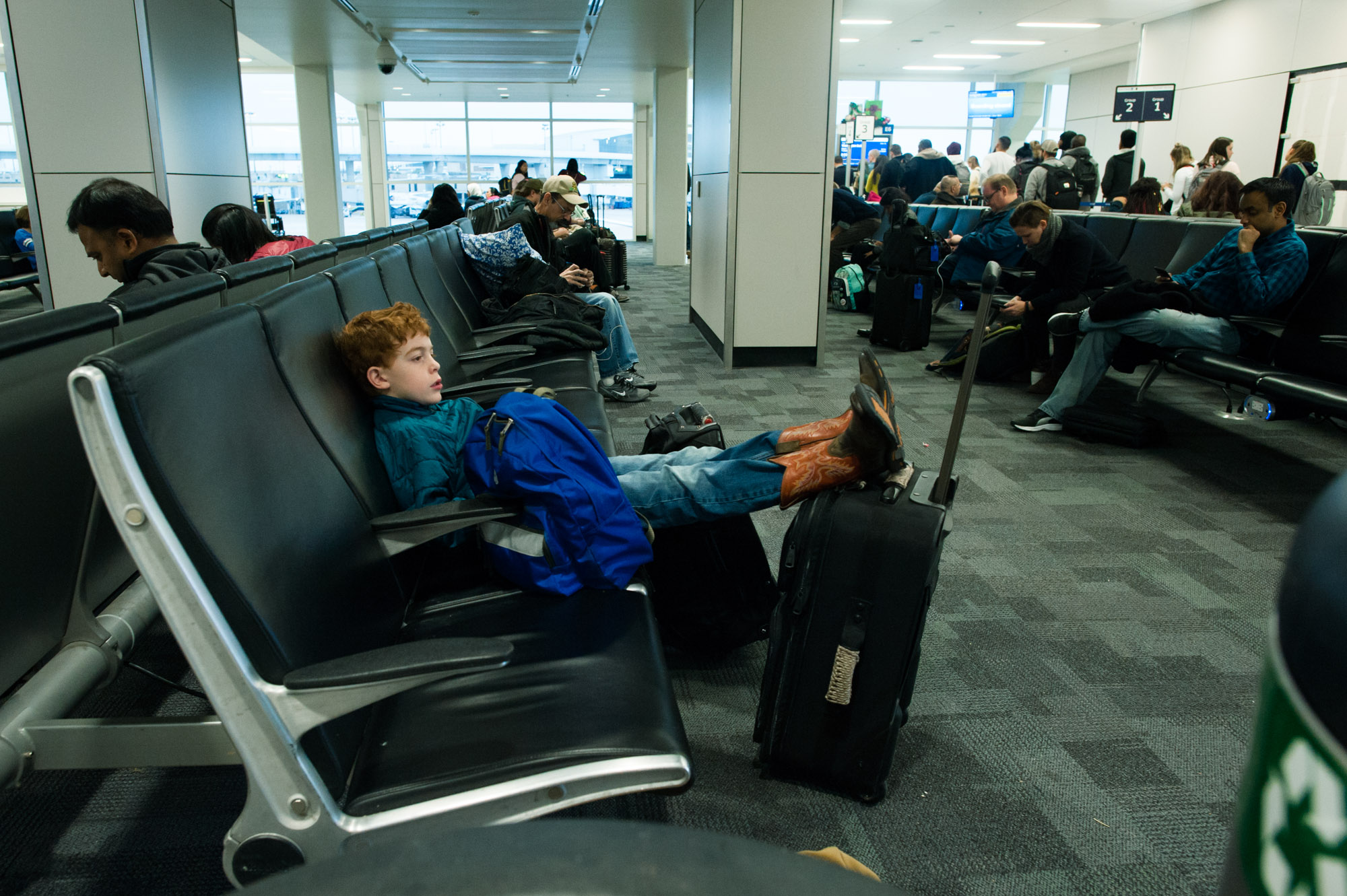 boy waits at airport - Documentary Family Photography