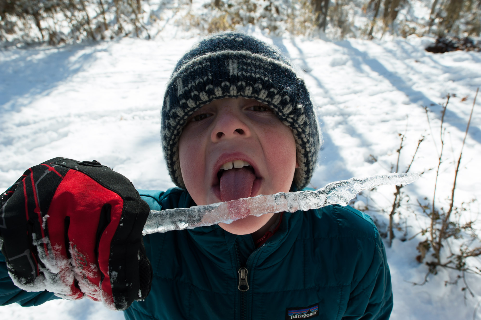 boy licks icicle - Documentary Family Photography