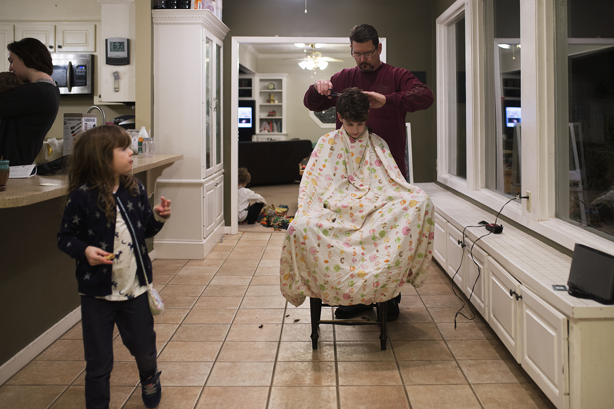 boy getting haircut in kitchen - documentary family photography