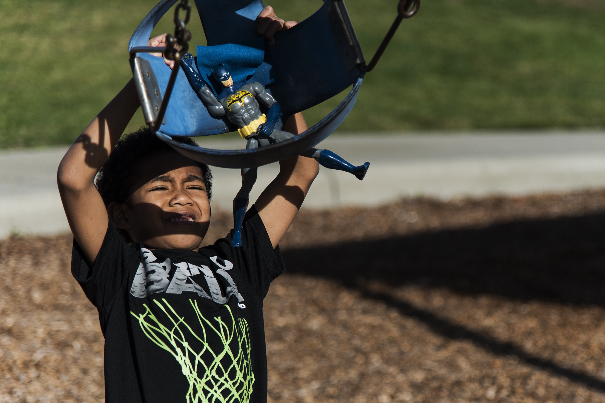 boy swinging action figure - documentary family photography