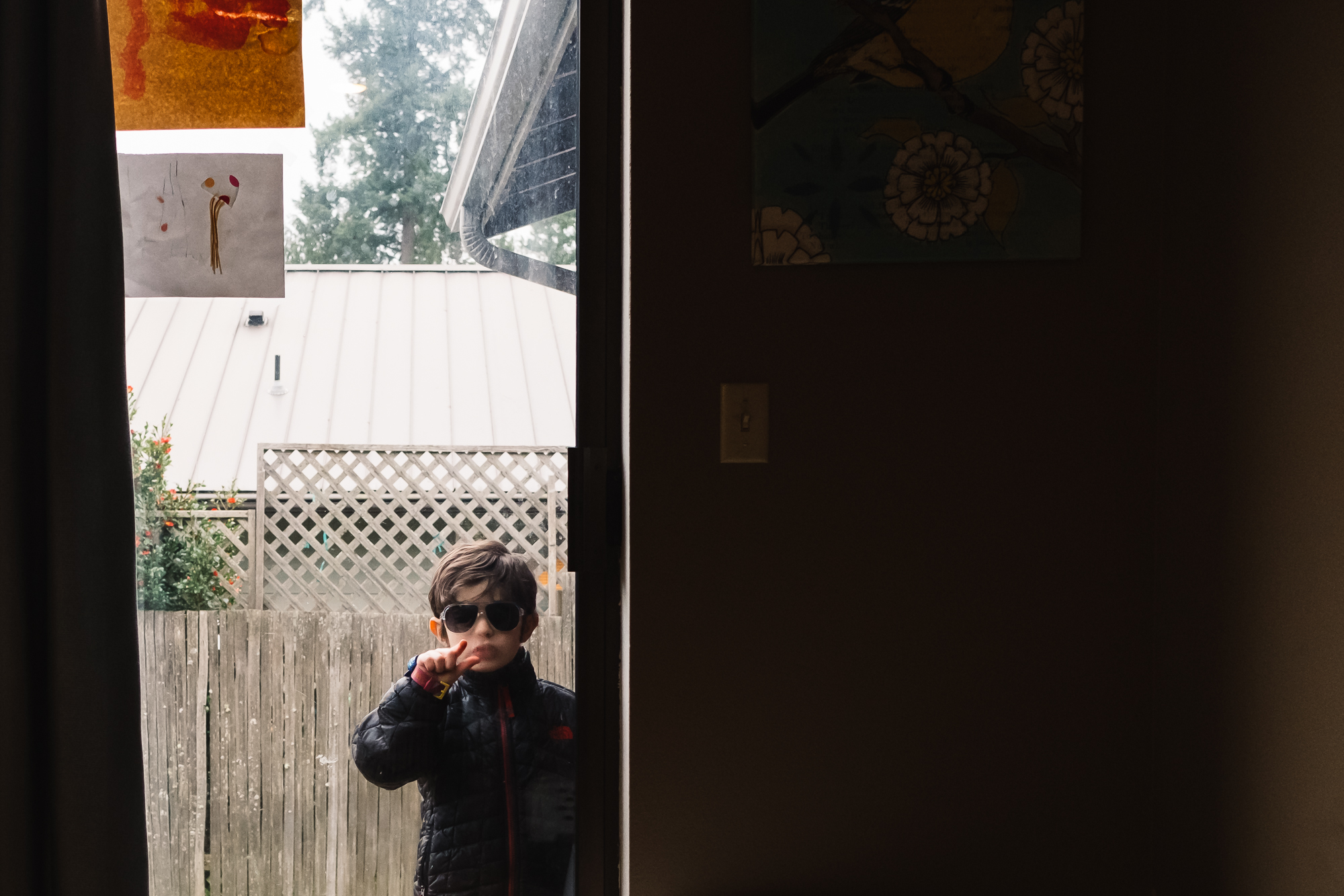 boy with sunglasses at window - Documentary Family Photography
