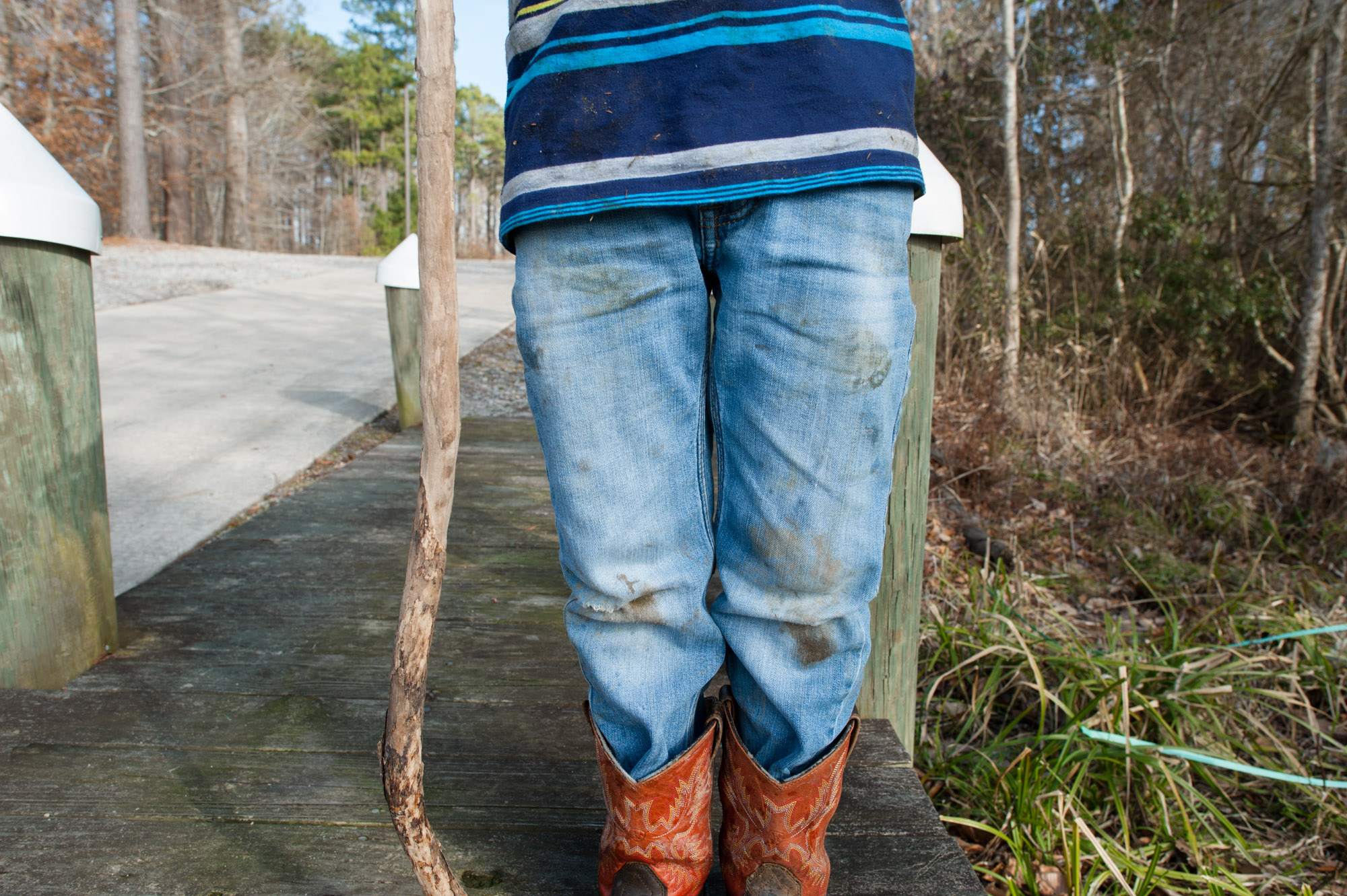 child with dirty jeans and cowboy boots - Documentary Family Photography