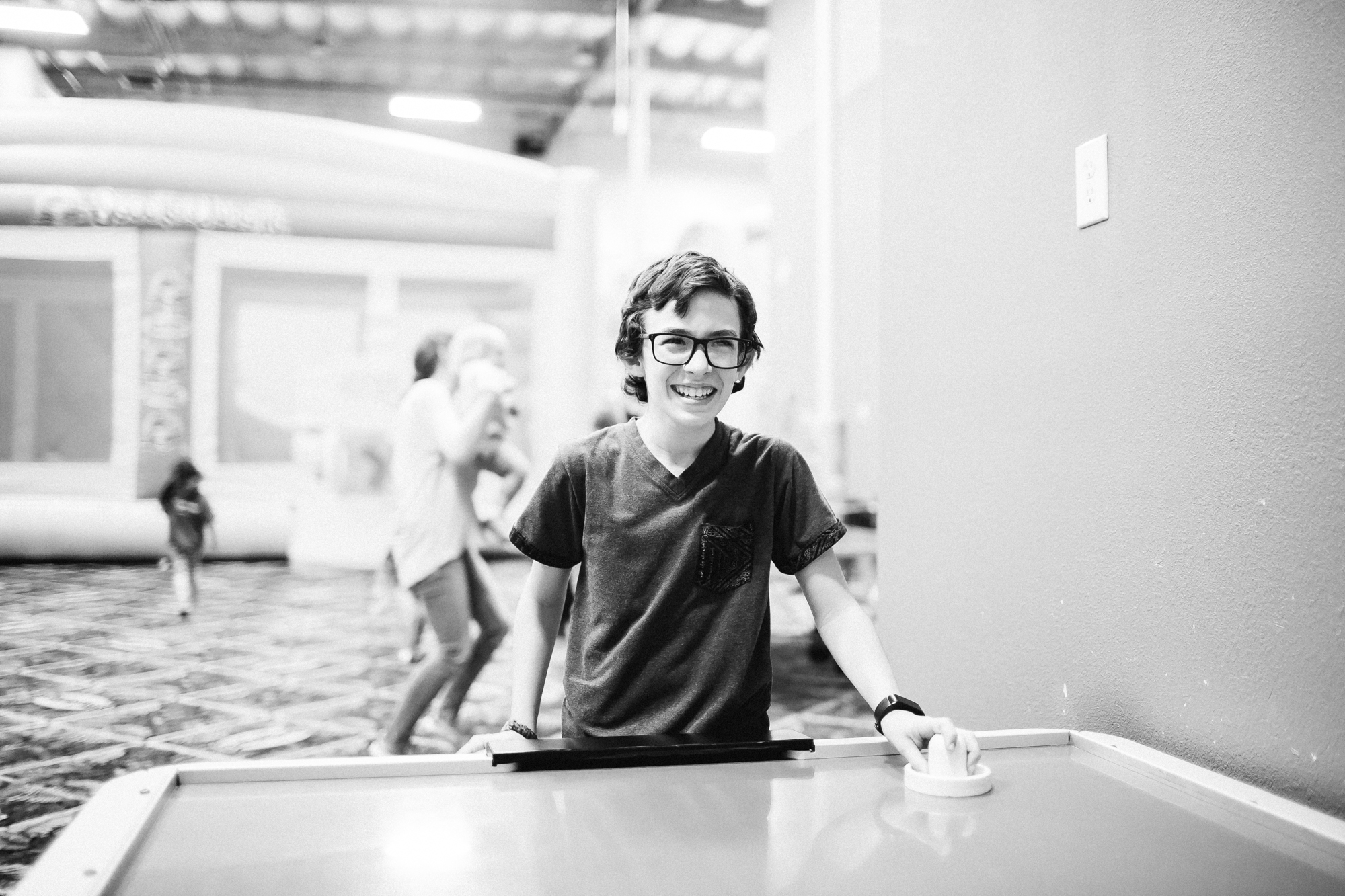 boy at air hockey table -Documentary Family Photography