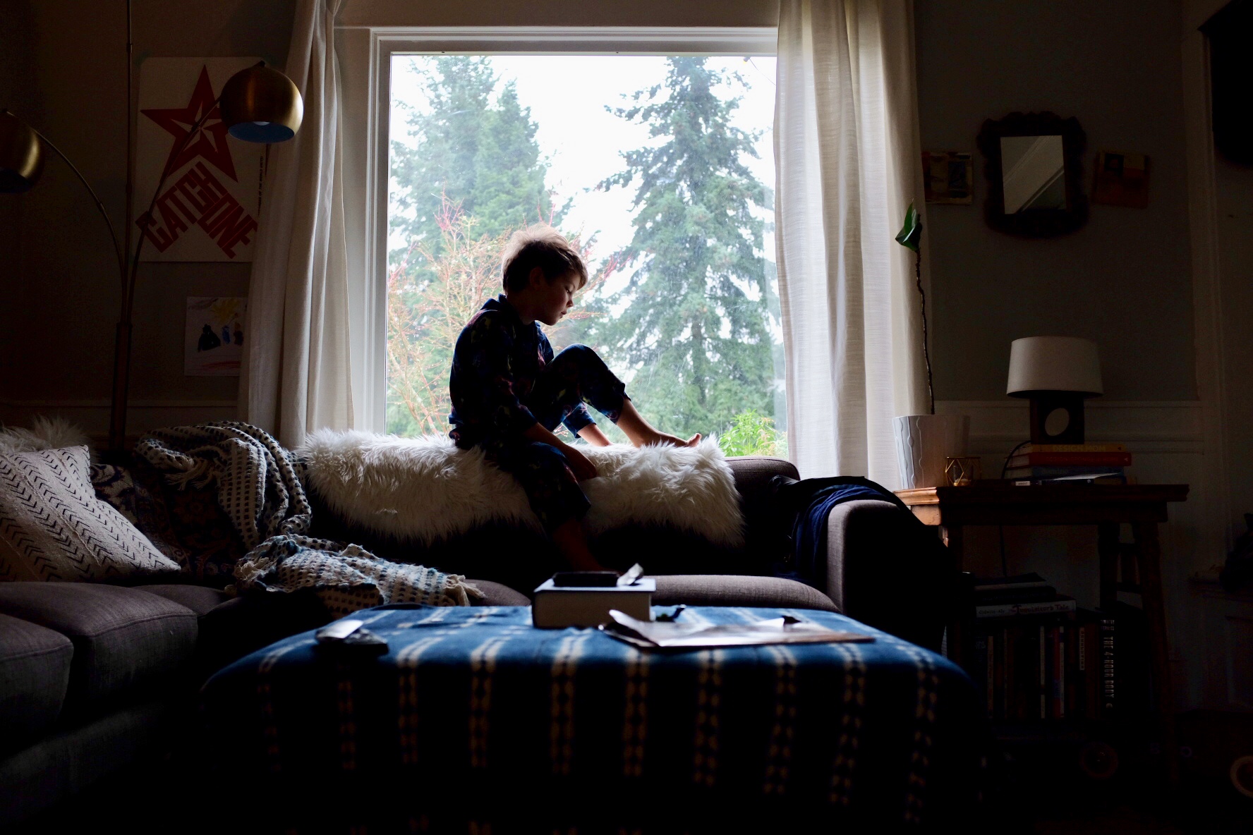 boy sitting on back of couch - Documentary Family Photography