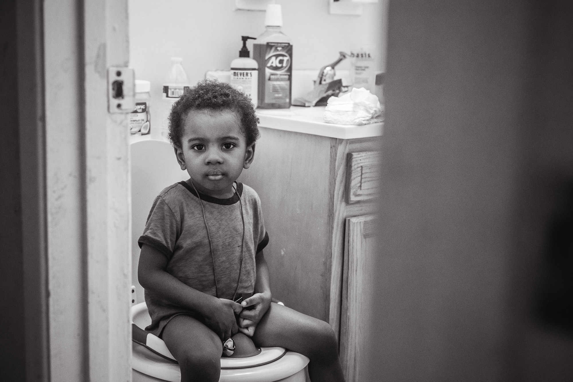 boy pouting on toilet - Documentary Family Photography