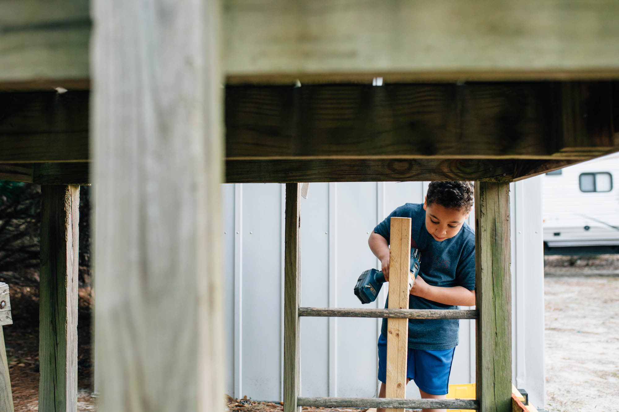 boy helps with building project - Documentary Family Photography