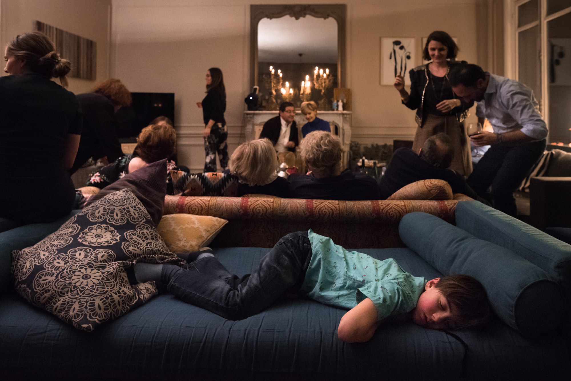 boy asleep in the middle of family gathering - Documentary Family Photography