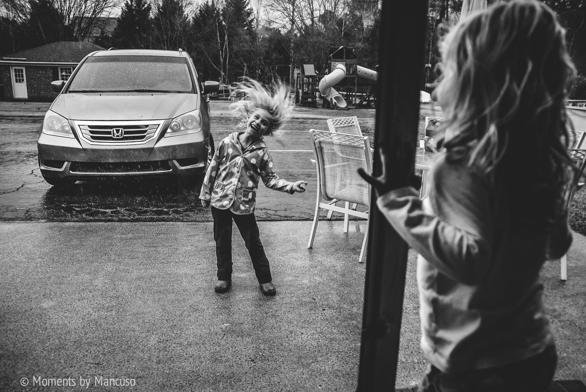 girl flips hair in the rain - documentary family photography