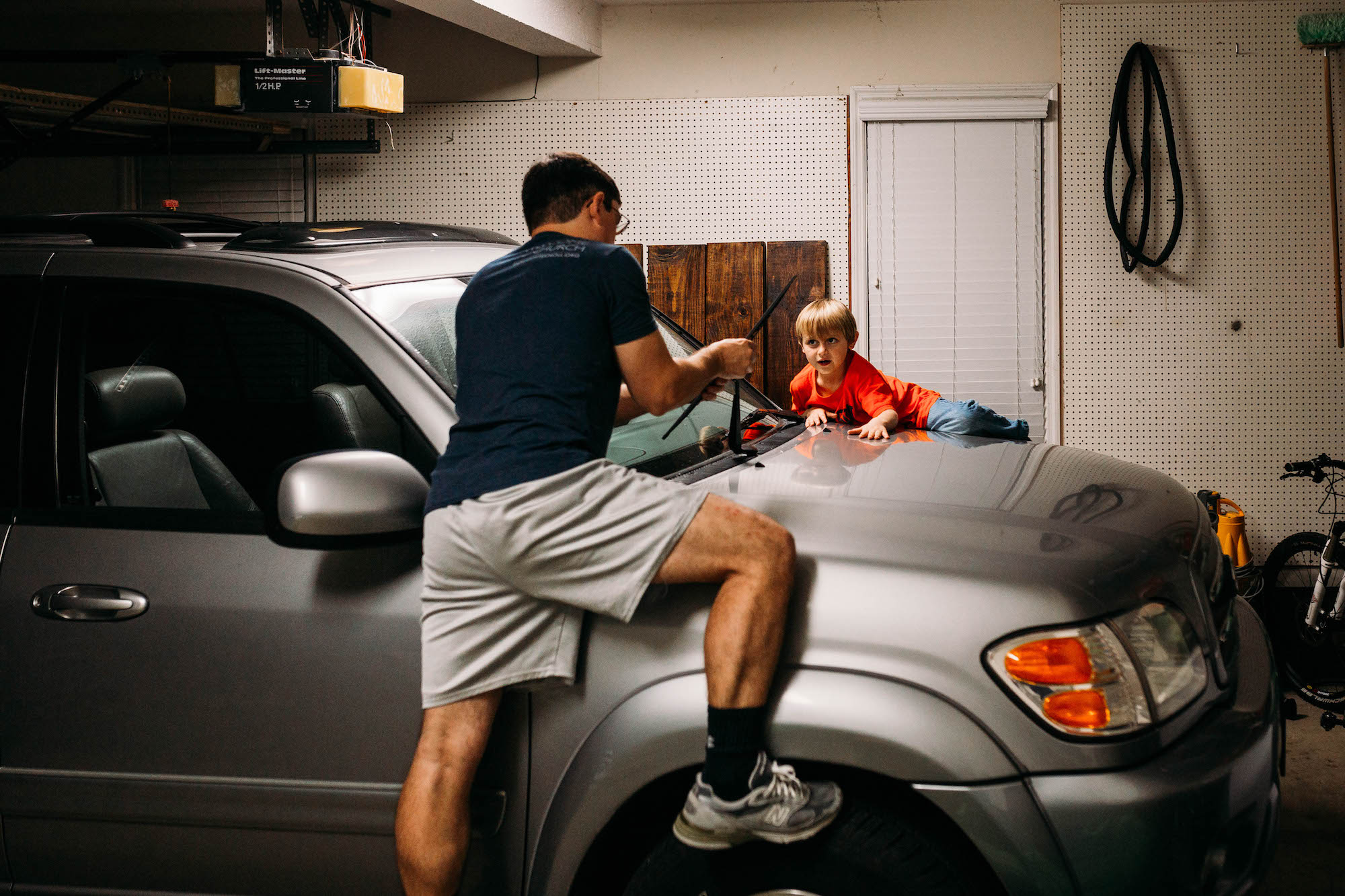 father and son changing wiper blades - Documentary Family Photography