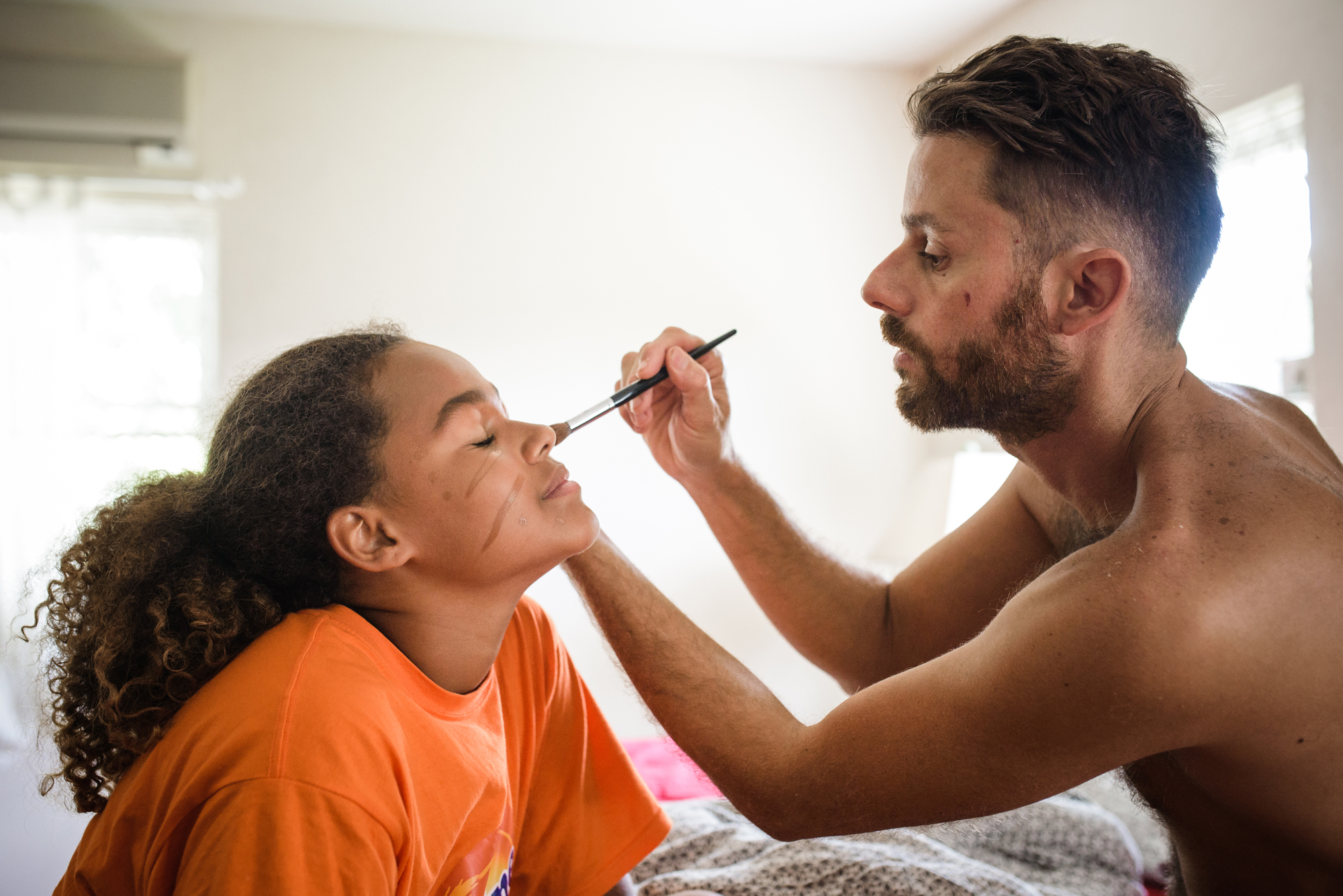 father helps daughter with makeup - Documentary Family Photography