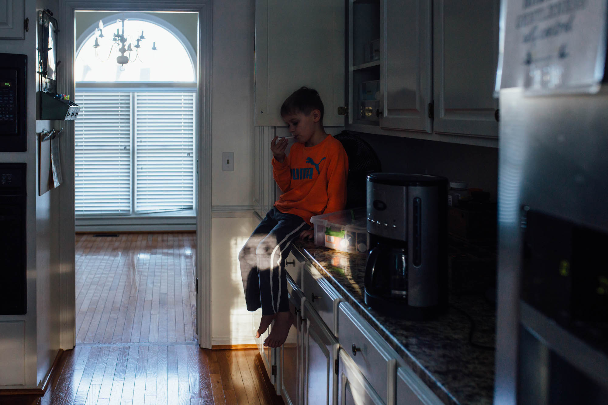 kid sitting on counter - Documentary Family Photography