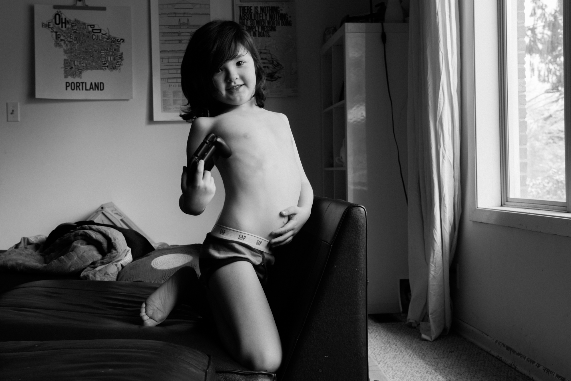 boy playing with belly button - Documentary Family Photography