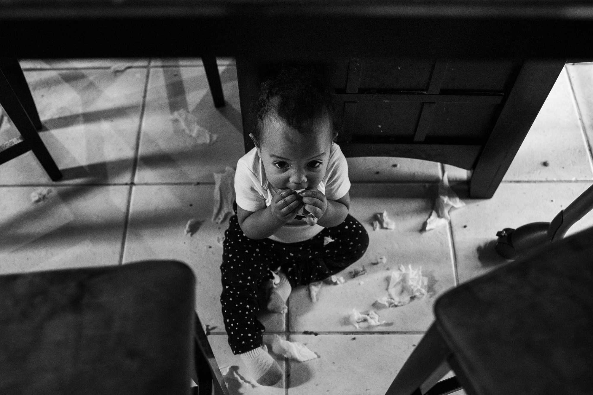 baby on floor with scraps - documentary family photography