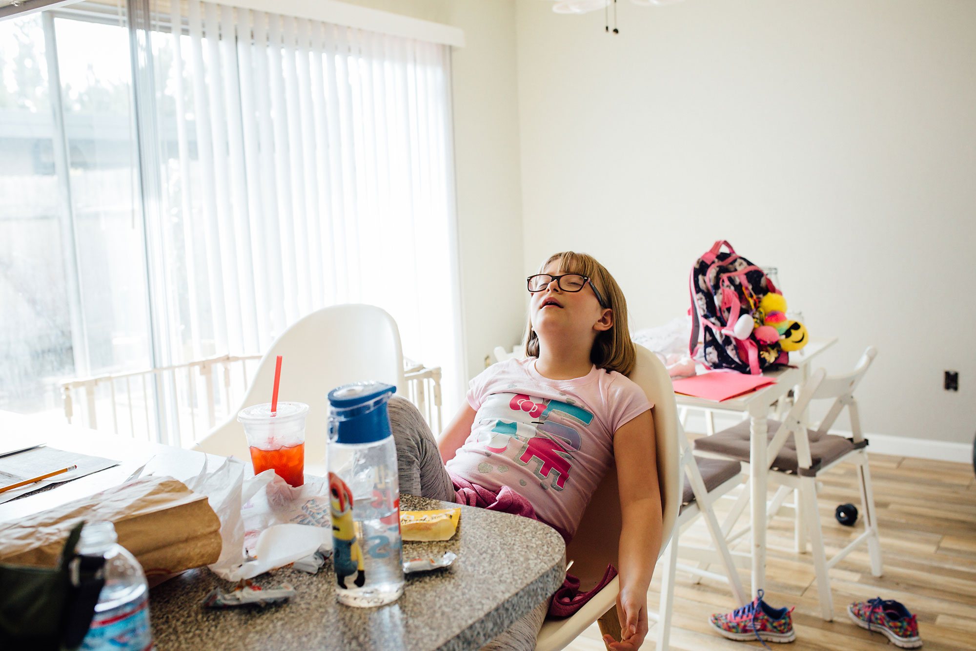 girl slumping in chair - documentary family photography